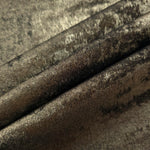 Antique Olive Lurex Italiano fabric in diagonal folds showing metallic sheen and drape for eveningwear.