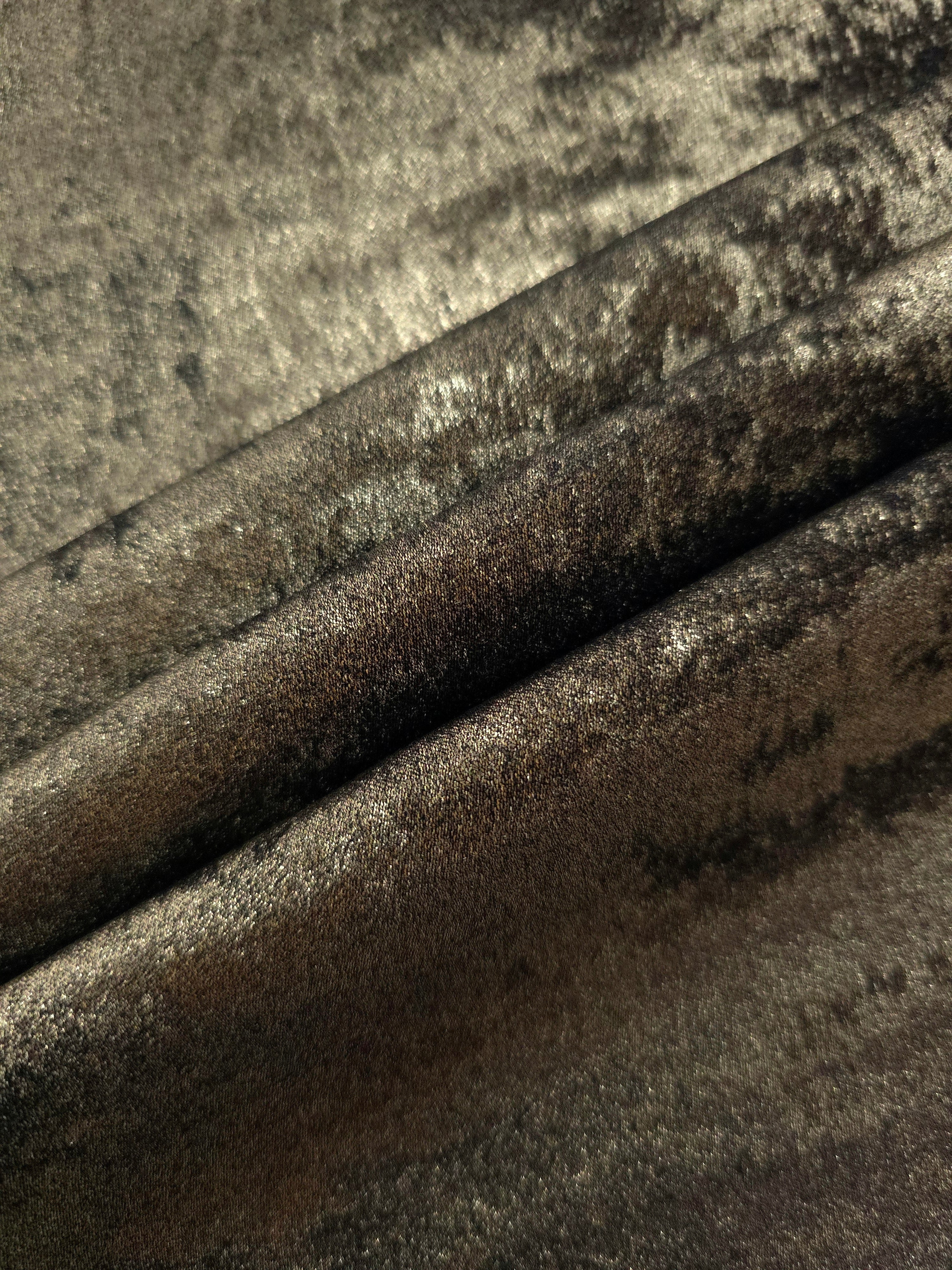 Antique Olive Lurex Italiano fabric in diagonal folds showing metallic sheen and drape for eveningwear.