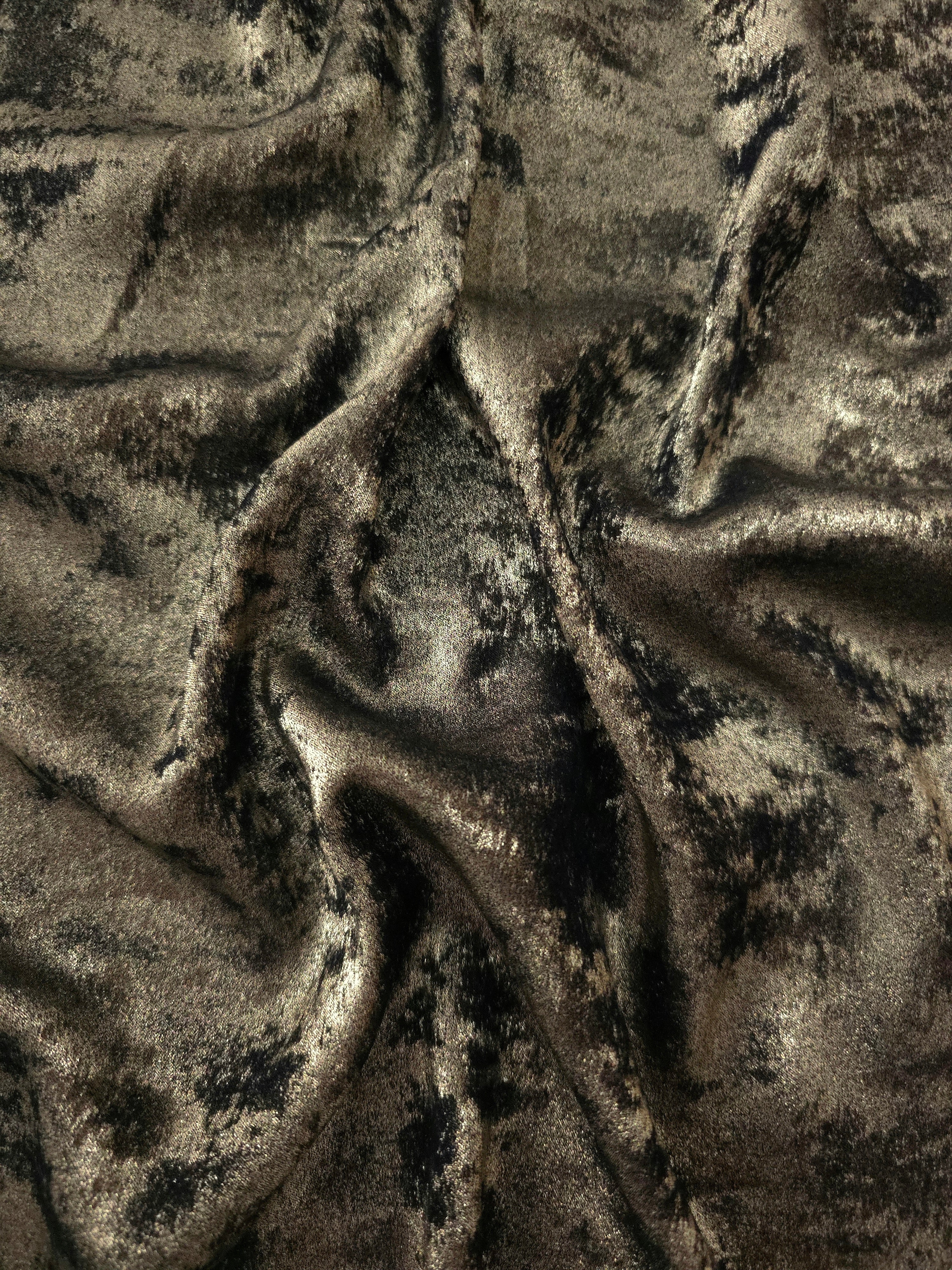 Flowing folds of Antique Olive Lurex Italiano fabric highlighting drape for abayas, kaftans and dresses.