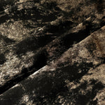 Black Bronze Lurex Italiano fabric in diagonal folds showing metallic sheen and drape for eveningwear.