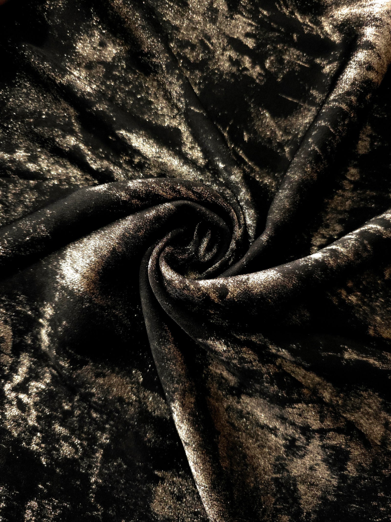 Rosette drape of Black Bronze Lurex Italiano fabric emphasizing shimmer for kaftans and occasionwear.