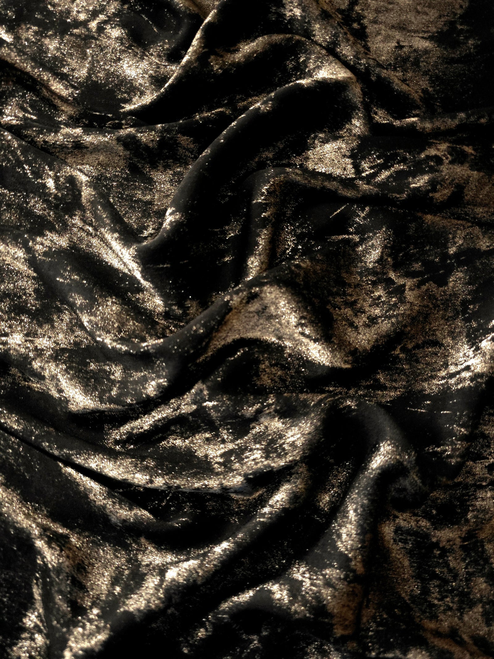 Reverse side of Black Bronze Lurex Italiano fabric showing the backing and metallic finish for garment production.