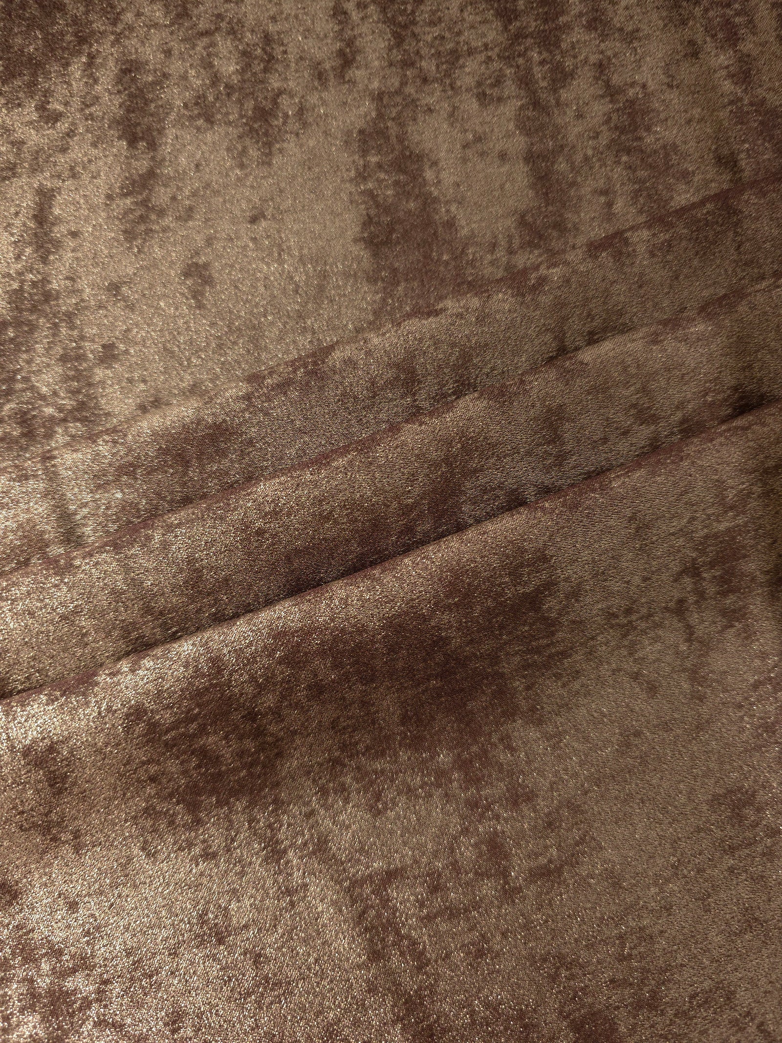 Bronze Taupe Lurex Italiano fabric in diagonal folds showing metallic sheen and drape for eveningwear.