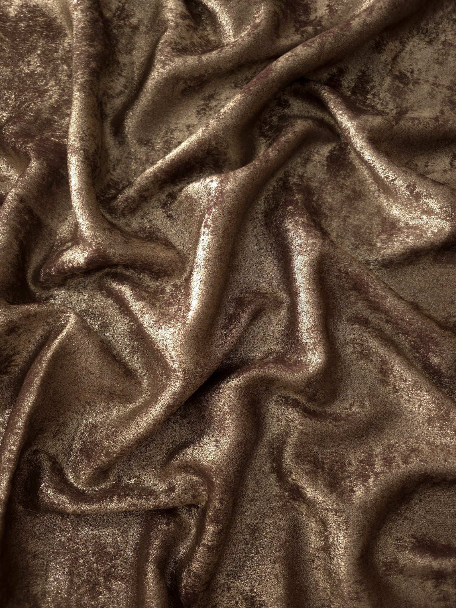 Flowing folds of Bronze Taupe Lurex Italiano fabric highlighting drape for abayas, kaftans and dresses.