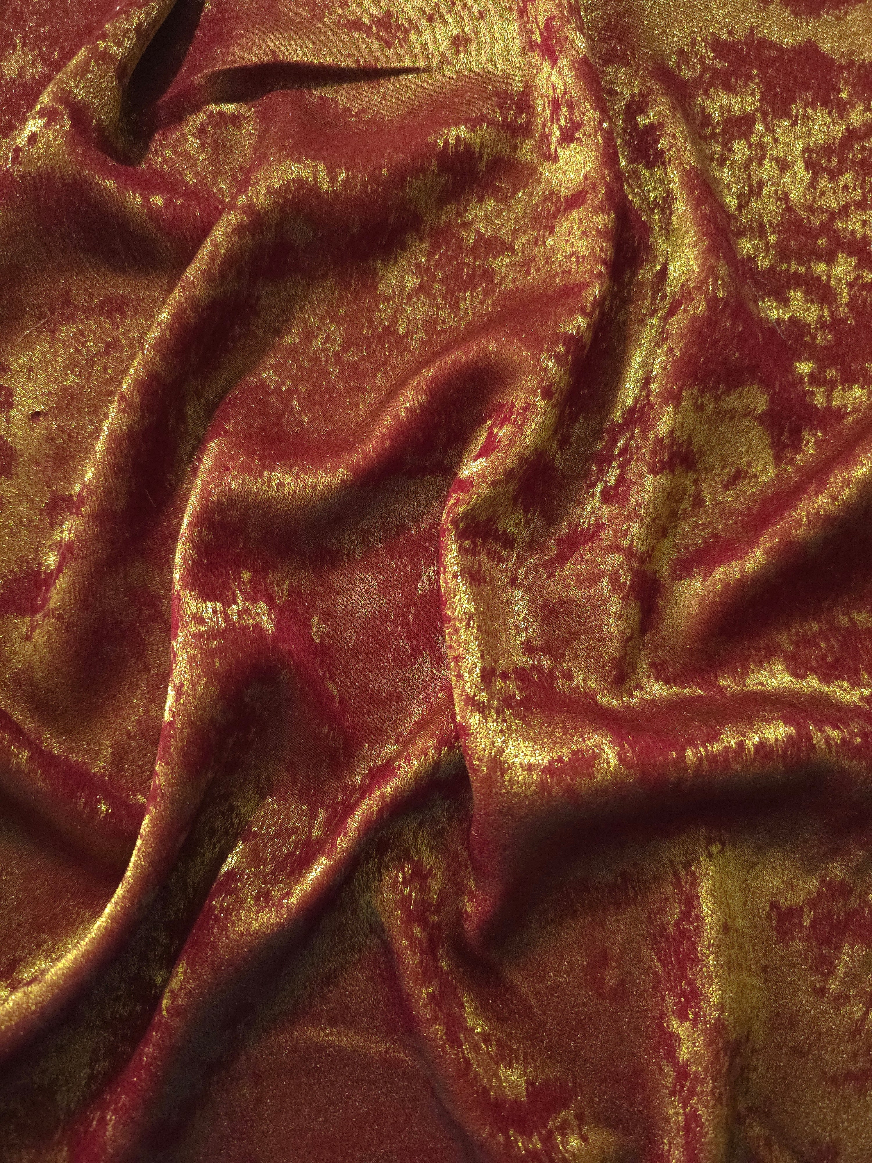 Flowing folds of Burgundy Gold Lurex Italiano fabric highlighting drape for abayas, kaftans and dresses.