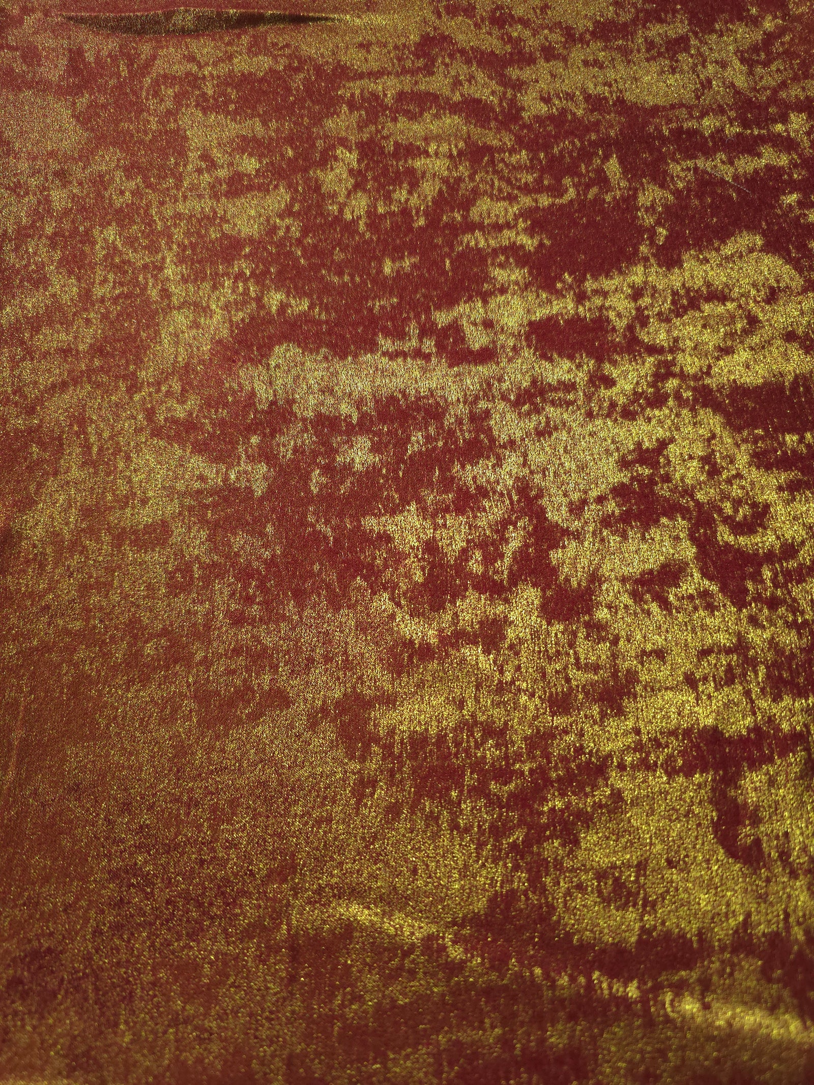 Flat view of Burgundy Gold Lurex Italiano fabric showing its metallic foil surface for luxury apparel.