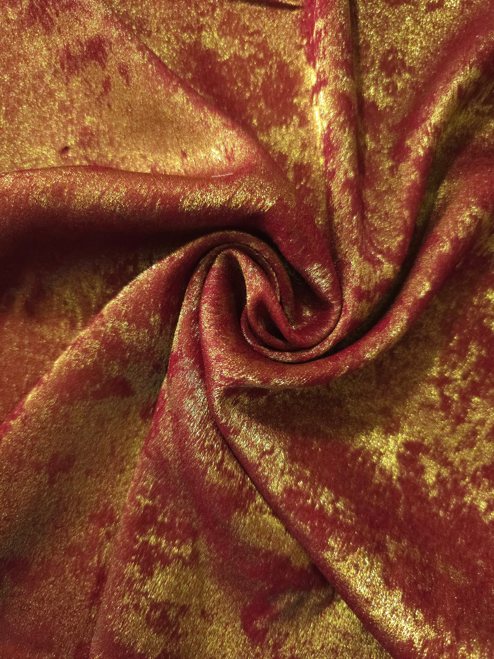 Rosette drape of Burgundy Gold Lurex Italiano fabric emphasizing shimmer for kaftans and occasionwear.
