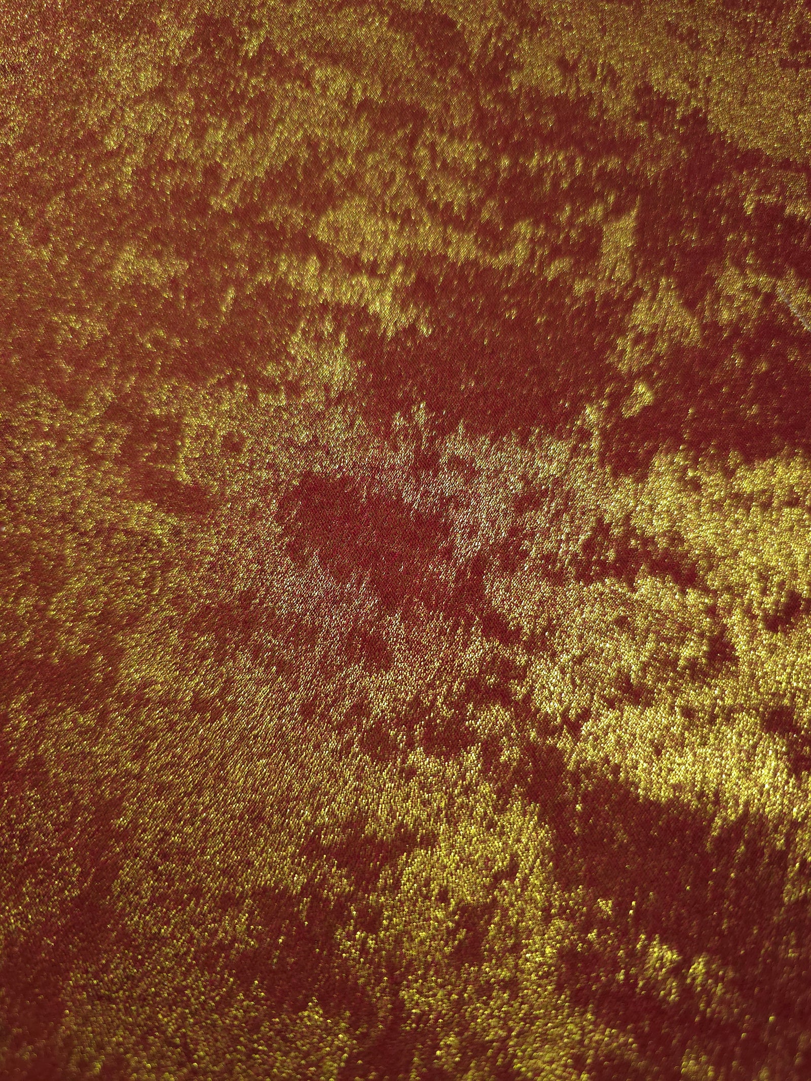 Macro close-up of Burgundy Gold Lurex Italiano fabric revealing metallic texture for designer apparel.
