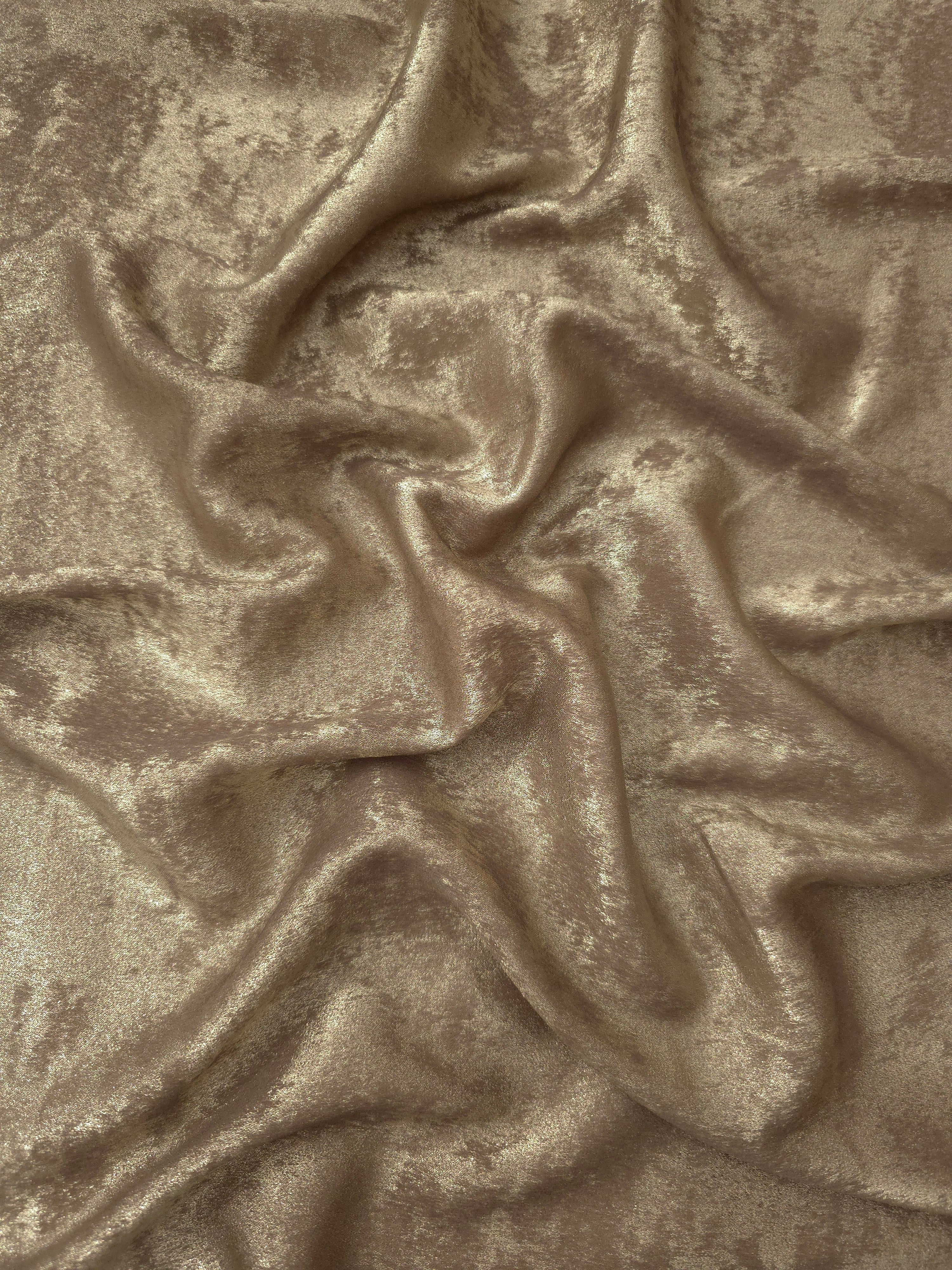 Flowing folds of Champagne Beige Lurex Italiano fabric highlighting drape for abayas, kaftans and dresses.