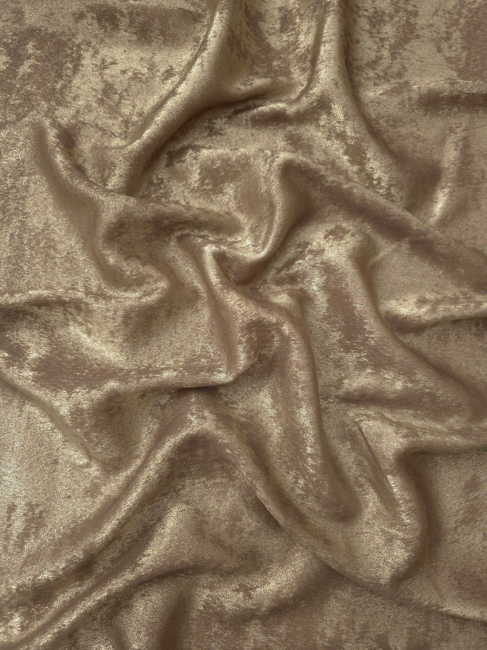 Flowing folds of Champagne Beige Lurex Italiano fabric highlighting drape for abayas, kaftans and dresses.