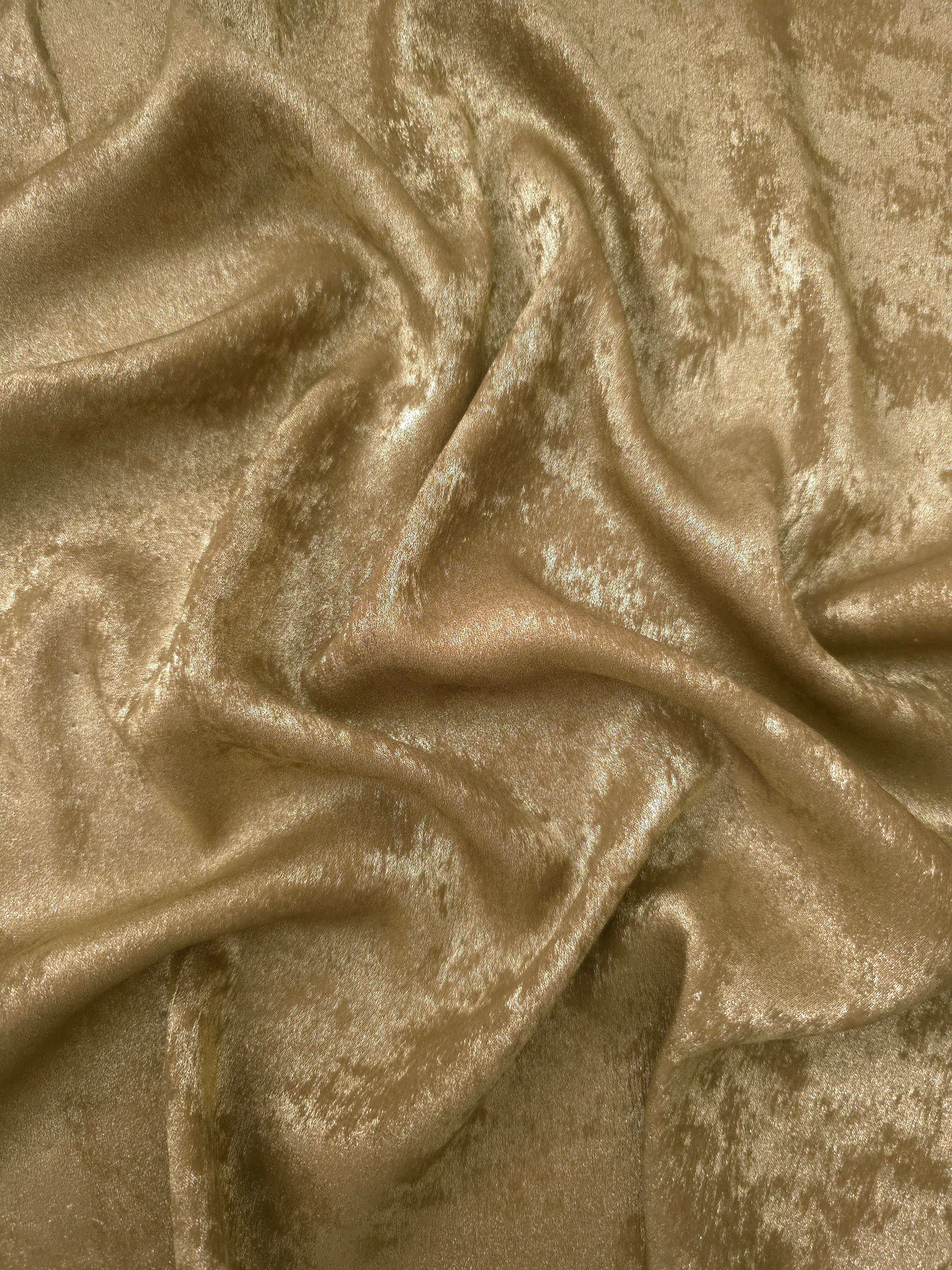 Flowing folds of Champagne Gold Lurex Italiano fabric highlighting drape for abayas, kaftans and dresses.