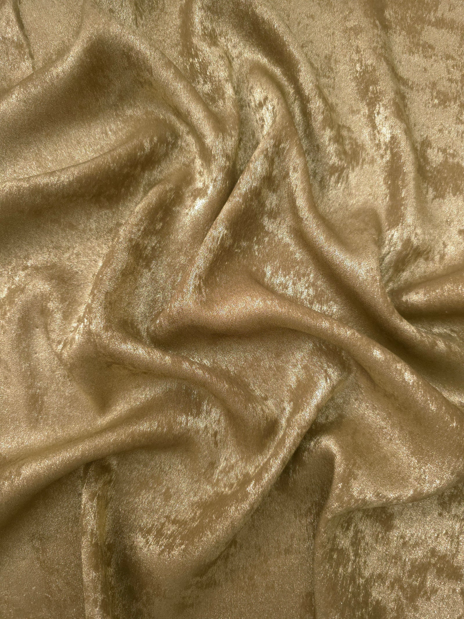 Flowing folds of Champagne Gold Lurex Italiano fabric highlighting drape for abayas, kaftans and dresses.