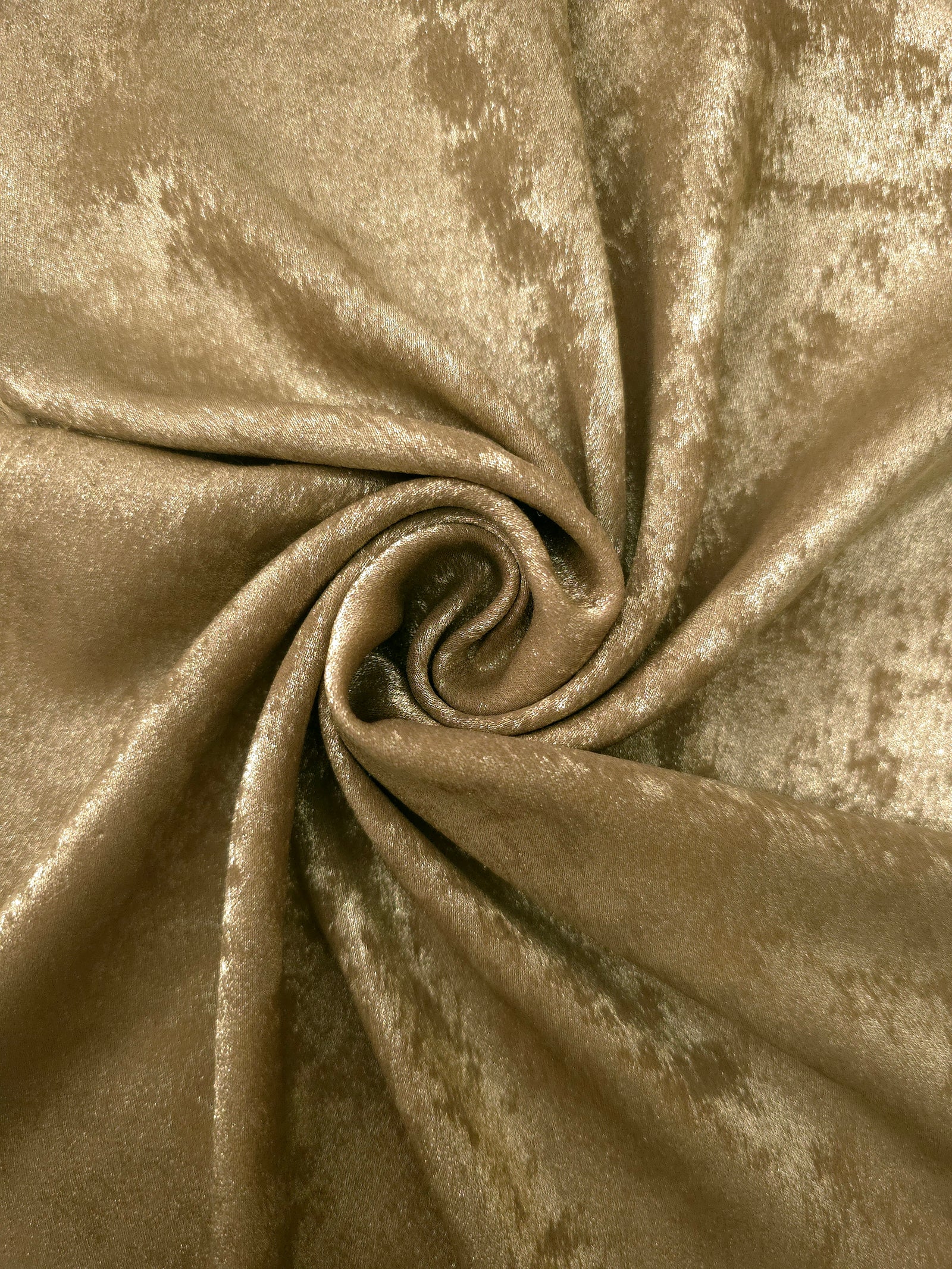 Rosette drape of Champagne Gold Lurex Italiano fabric emphasizing shimmer for kaftans and occasionwear.