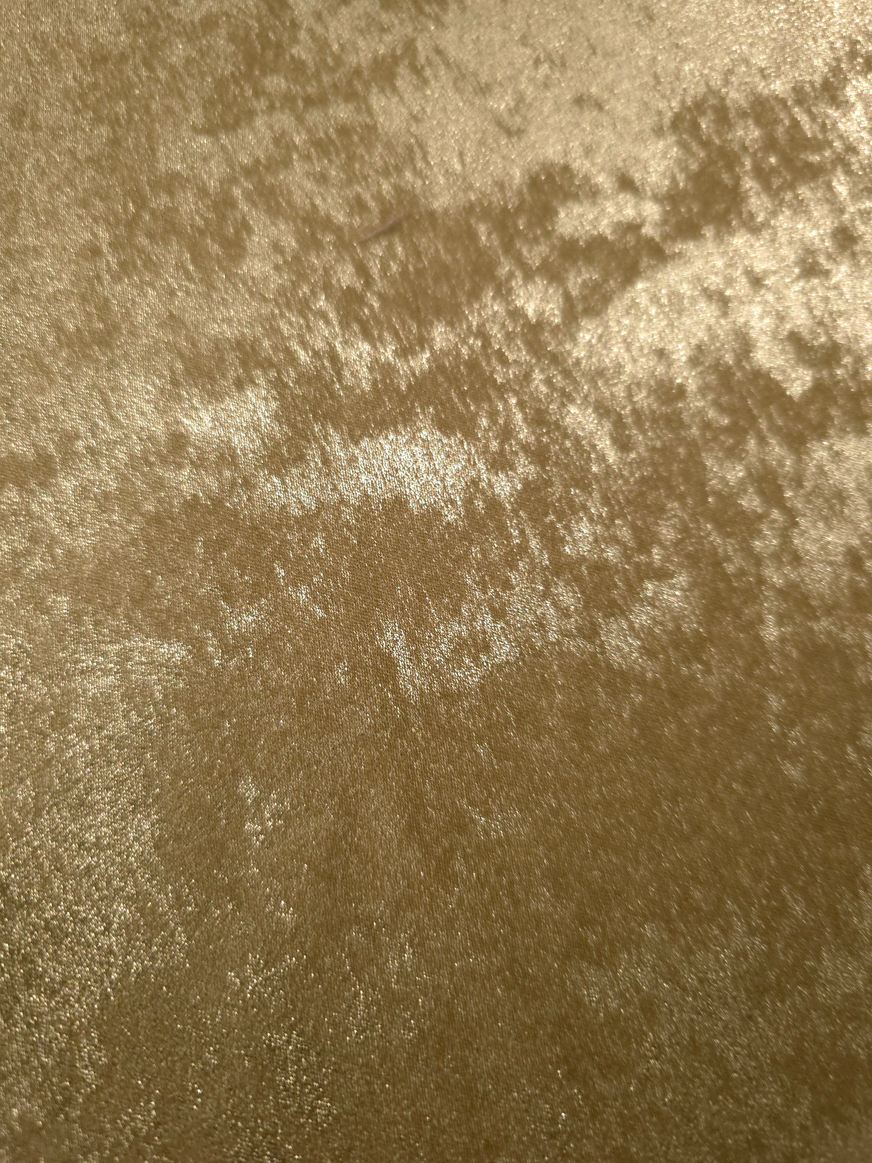 Macro close-up of Champagne Gold Lurex Italiano fabric revealing metallic texture for designer apparel.