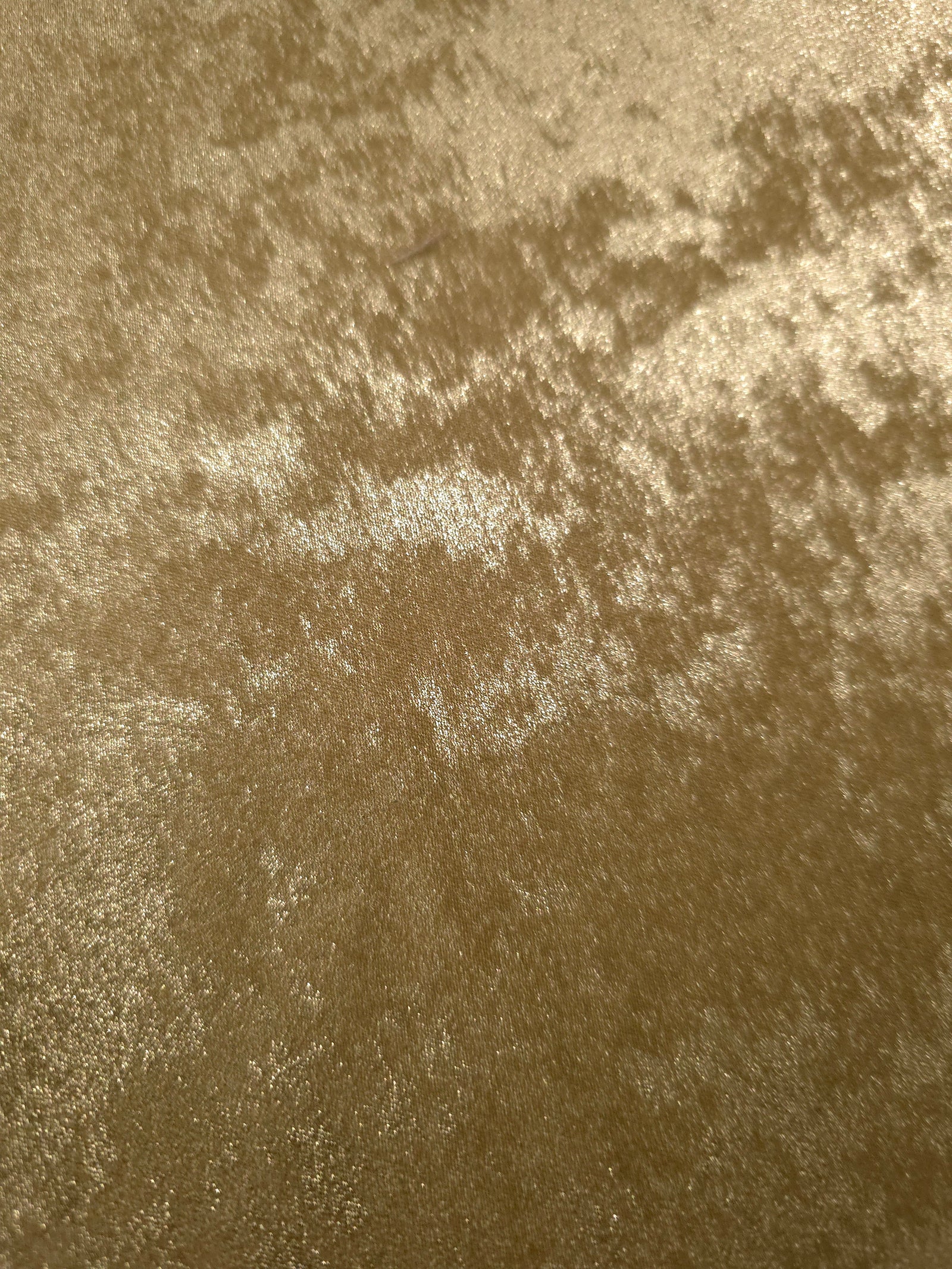 Macro close-up of Champagne Gold Lurex Italiano fabric revealing metallic texture for designer apparel.