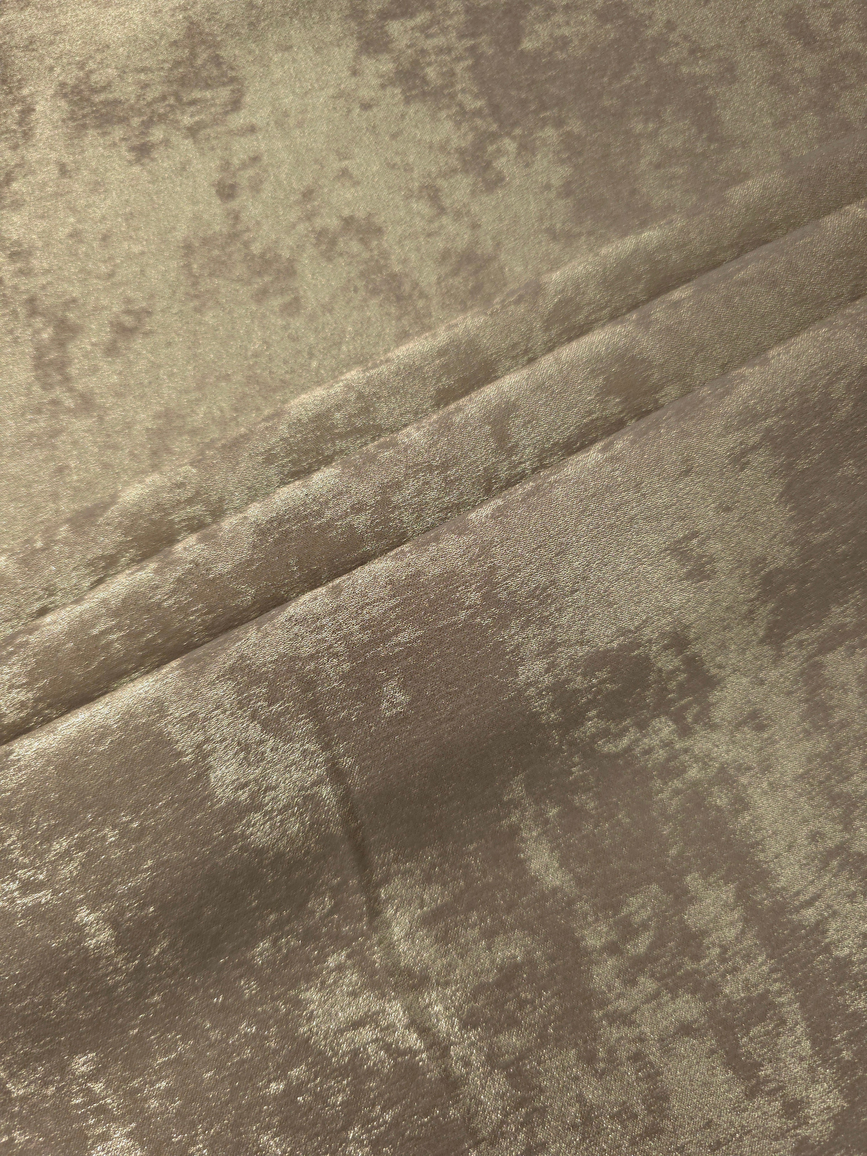 Champagne Taupe Lurex Italiano fabric in diagonal folds showing metallic sheen and drape for eveningwear.