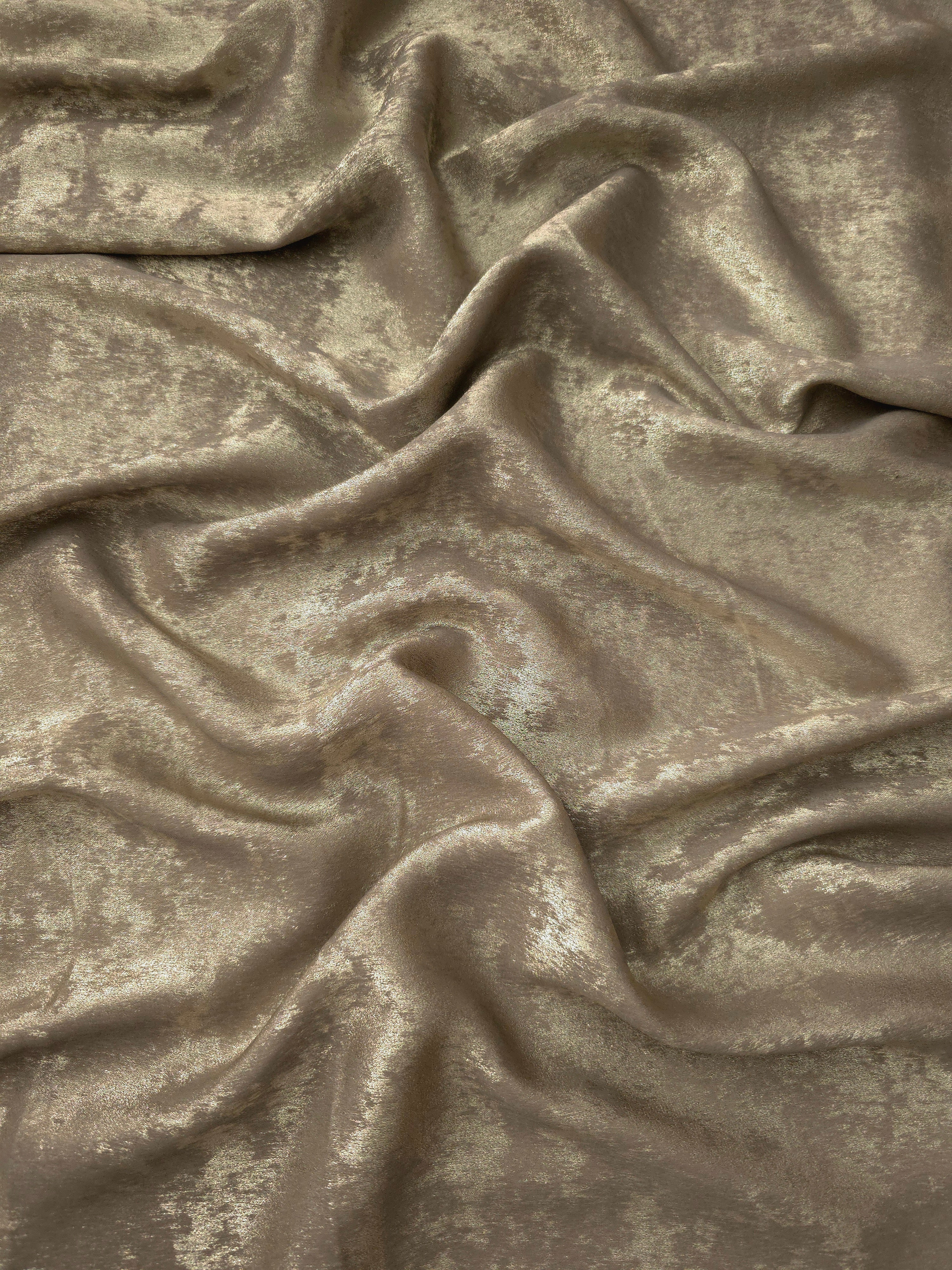 Flowing folds of Champagne Taupe Lurex Italiano fabric highlighting drape for abayas, kaftans and dresses.