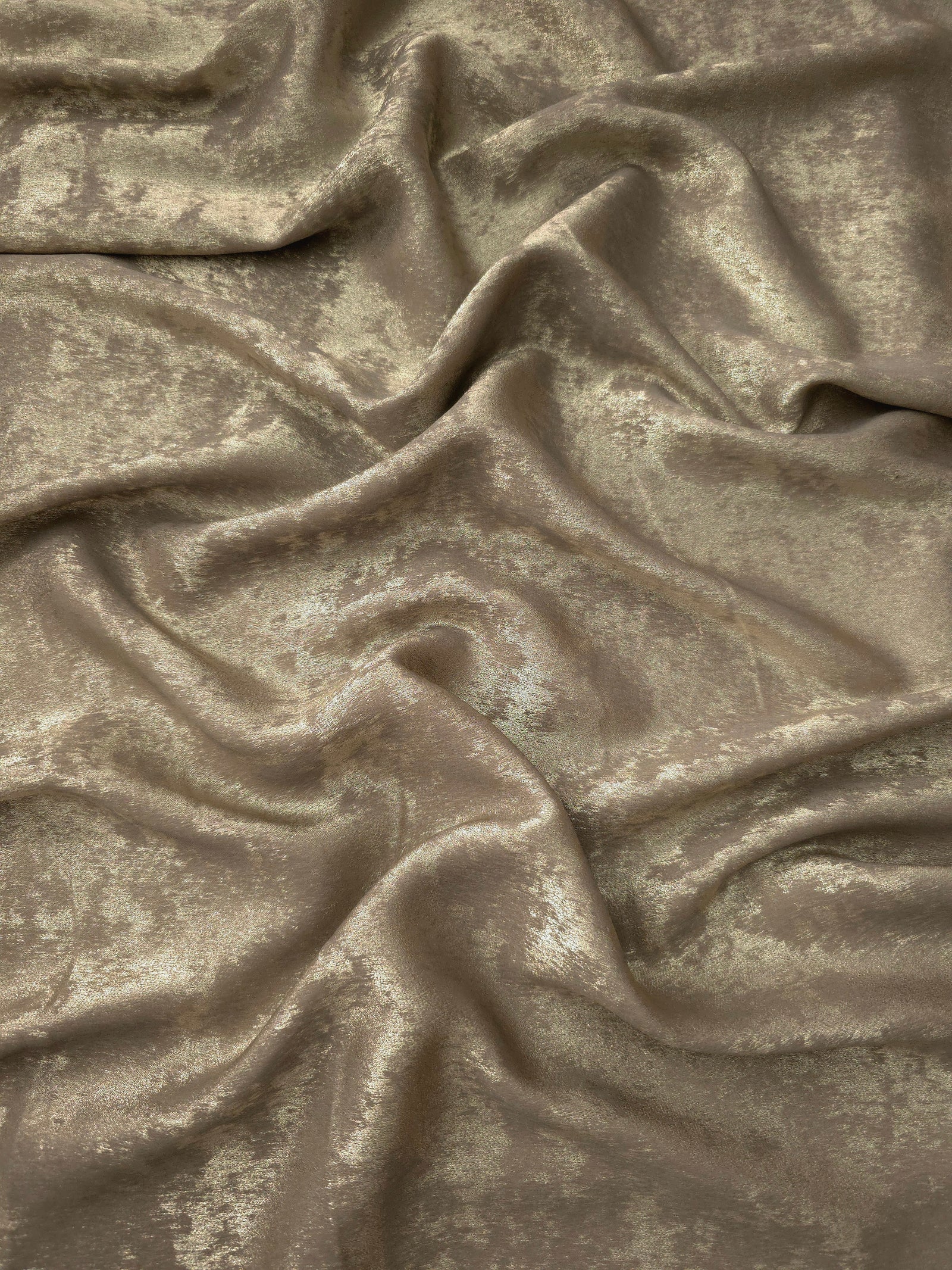 Flowing folds of Champagne Taupe Lurex Italiano fabric highlighting drape for abayas, kaftans and dresses.