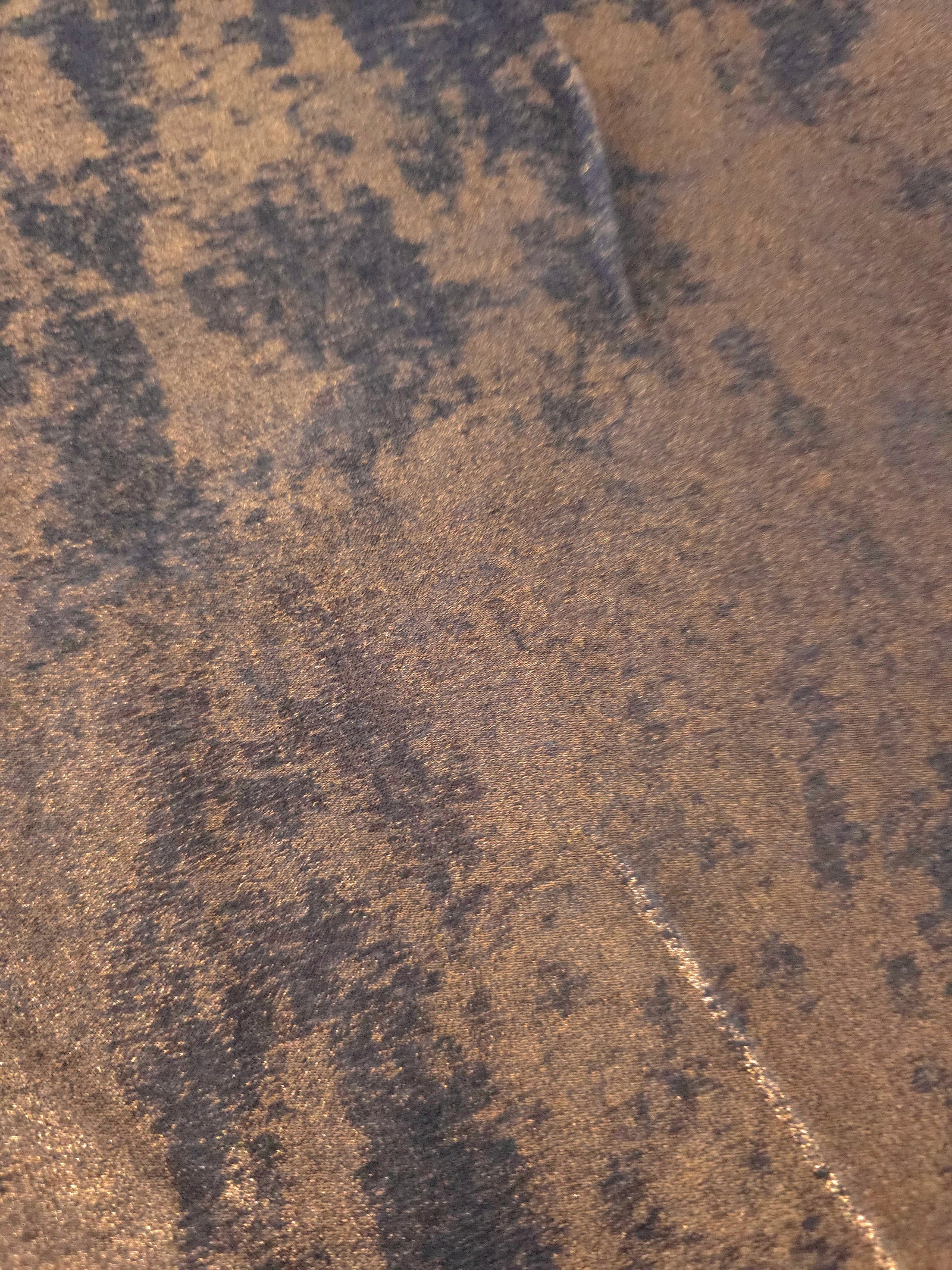 Macro close-up of Cocoa Bronze Lurex Italiano fabric revealing metallic texture for designer apparel.