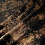 Copper Black Lurex Italiano fabric in diagonal folds showing metallic sheen and drape for eveningwear.