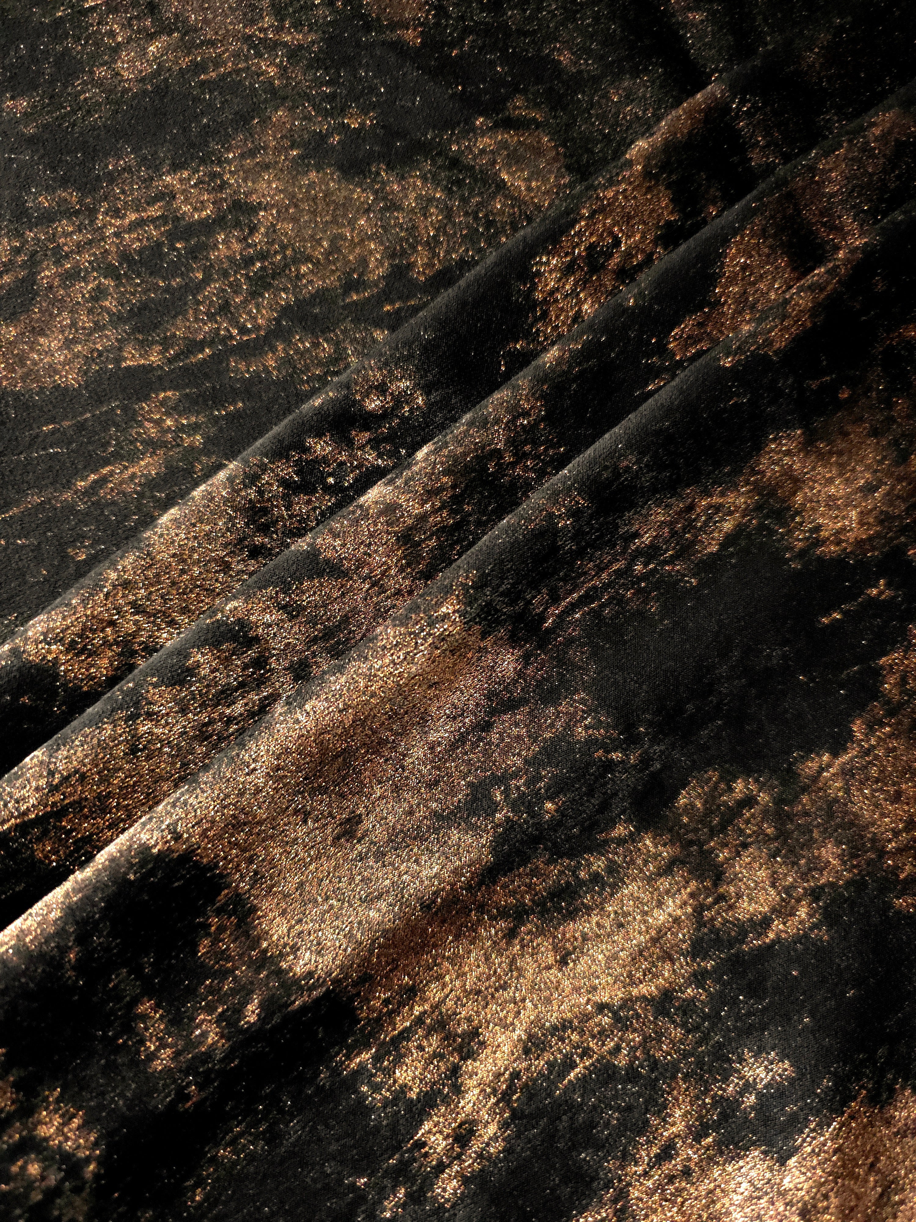 Copper Black Lurex Italiano metallic fabric arranged in diagonal folds for eveningwear