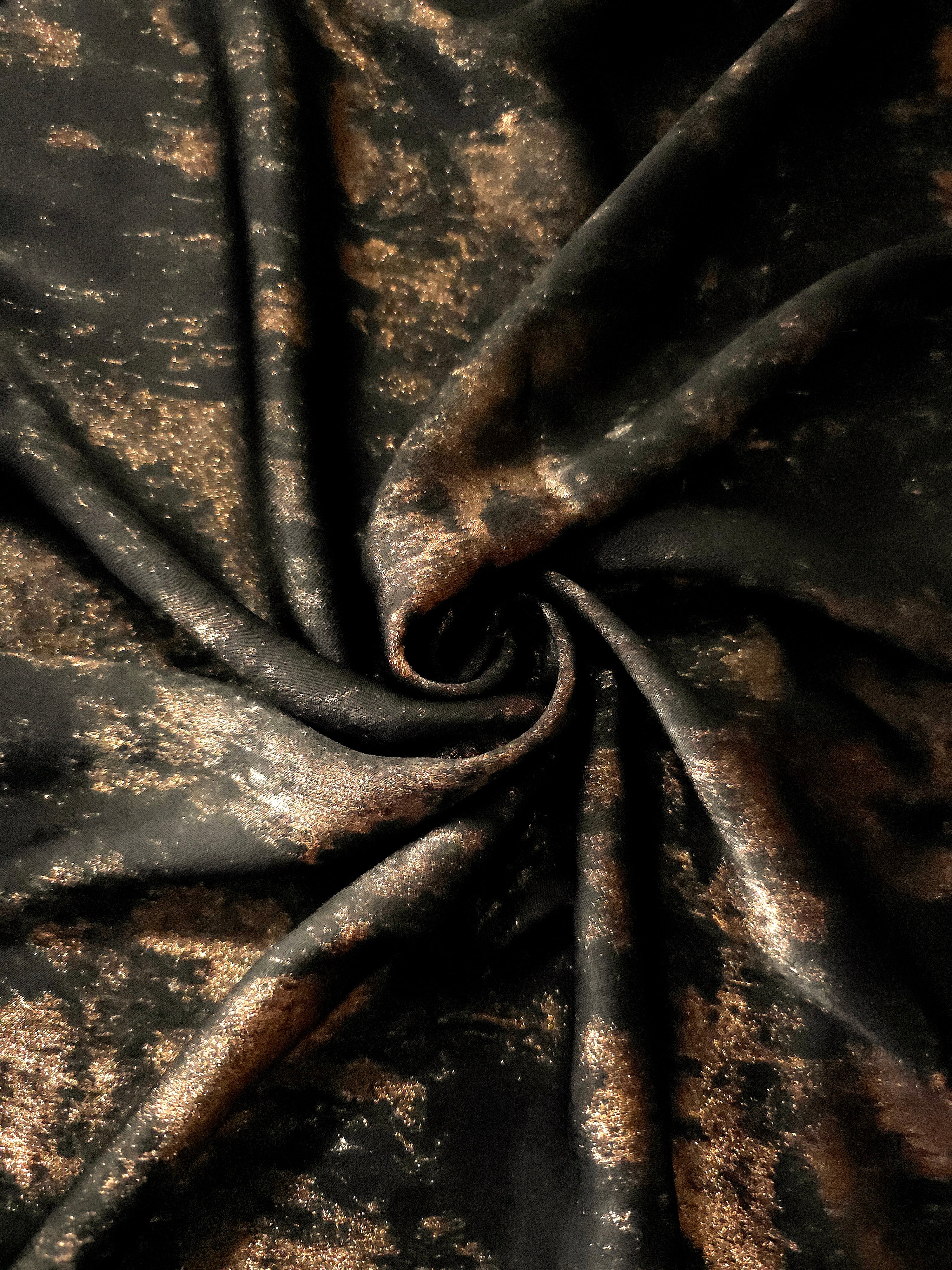 Copper Black Lurex Italiano metallic fabric in a rosette drape showing reflective shimmer