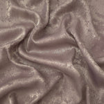 Dusty Mauve Lurex Italiano fabric in diagonal folds showing metallic sheen and drape for eveningwear.