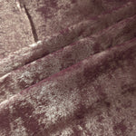 Dusty Plum Lurex Italiano fabric in diagonal folds showing metallic sheen and drape for eveningwear.