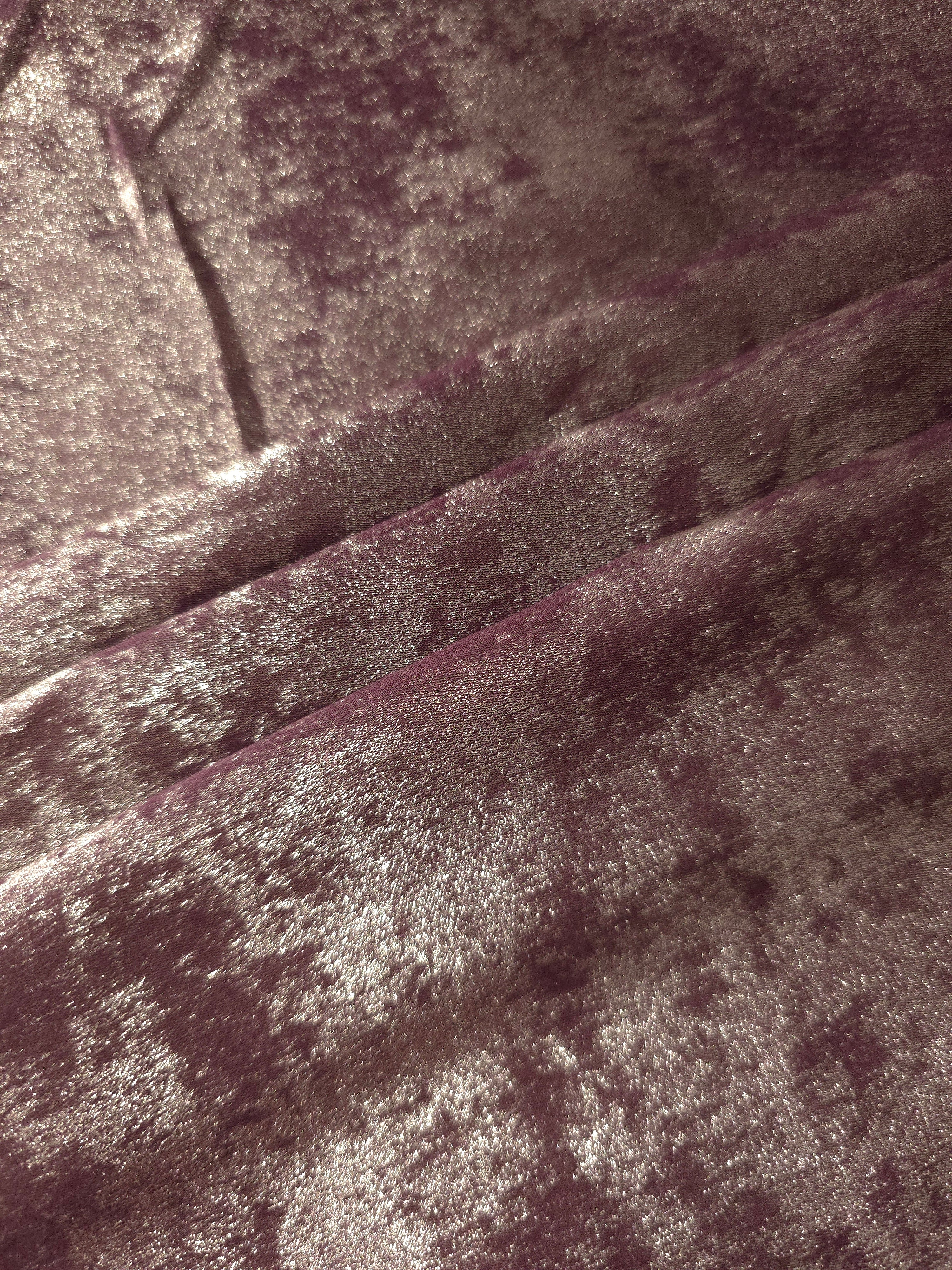Dusty Plum Lurex Italiano fabric in diagonal folds showing metallic sheen and drape for eveningwear.