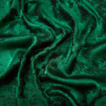 Flowing folds of Emerald Green Lurex Italiano fabric highlighting drape for abayas, kaftans and dresses.