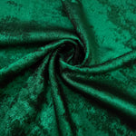 Rosette drape of Emerald Green Lurex Italiano fabric emphasizing shimmer for kaftans and occasionwear.