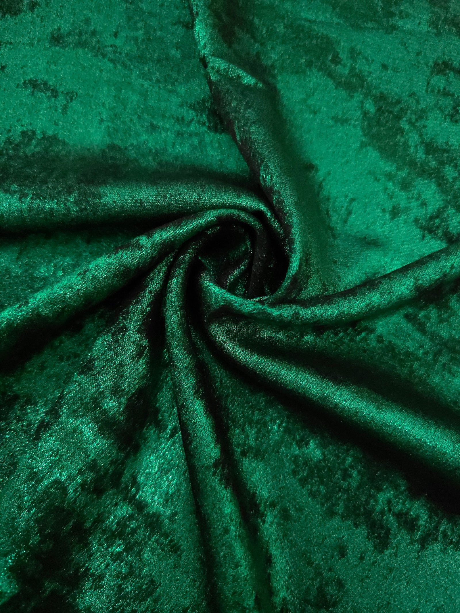 Rosette drape of Emerald Green Lurex Italiano fabric emphasizing shimmer for kaftans and occasionwear.