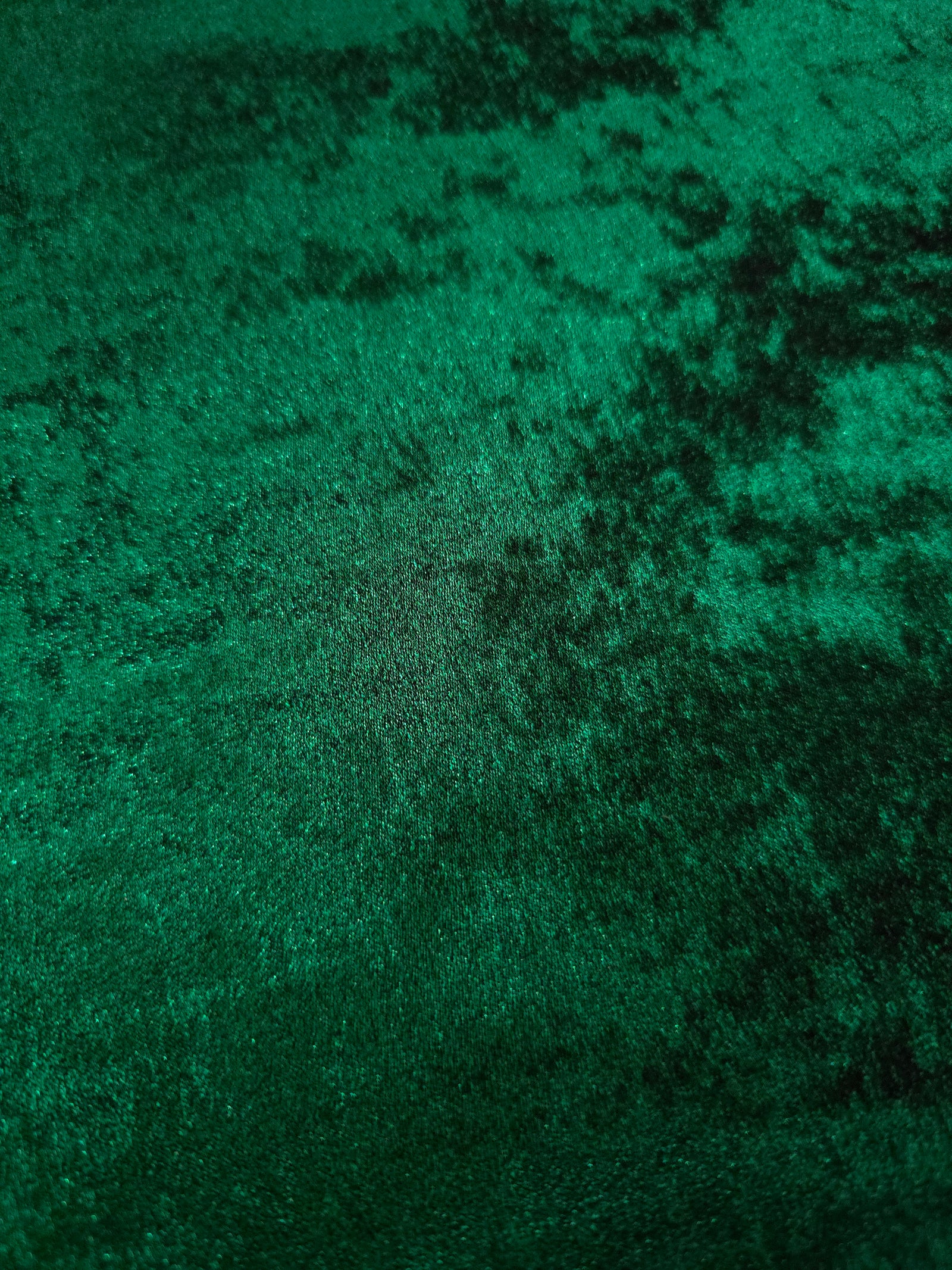 Macro close-up of Emerald Green Lurex Italiano fabric revealing metallic texture for designer apparel.