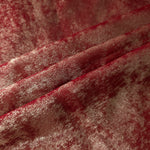 Garnet Rose Lurex Italiano fabric in diagonal folds showing metallic sheen and drape for eveningwear.