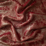 Flowing folds of Garnet Rose Lurex Italiano fabric highlighting drape for abayas, kaftans and dresses.