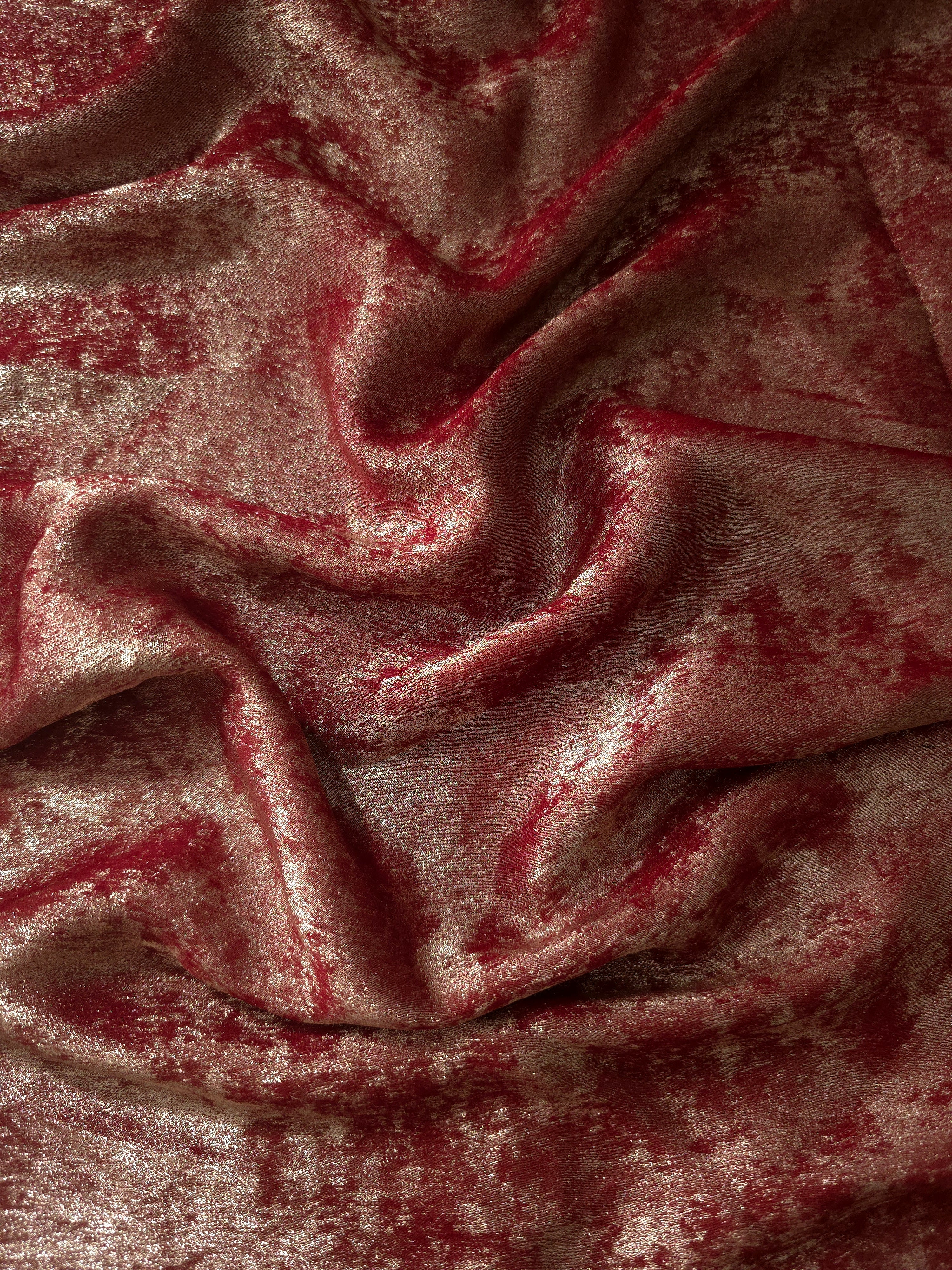 Flowing folds of Garnet Rose Lurex Italiano fabric highlighting drape for abayas, kaftans and dresses.