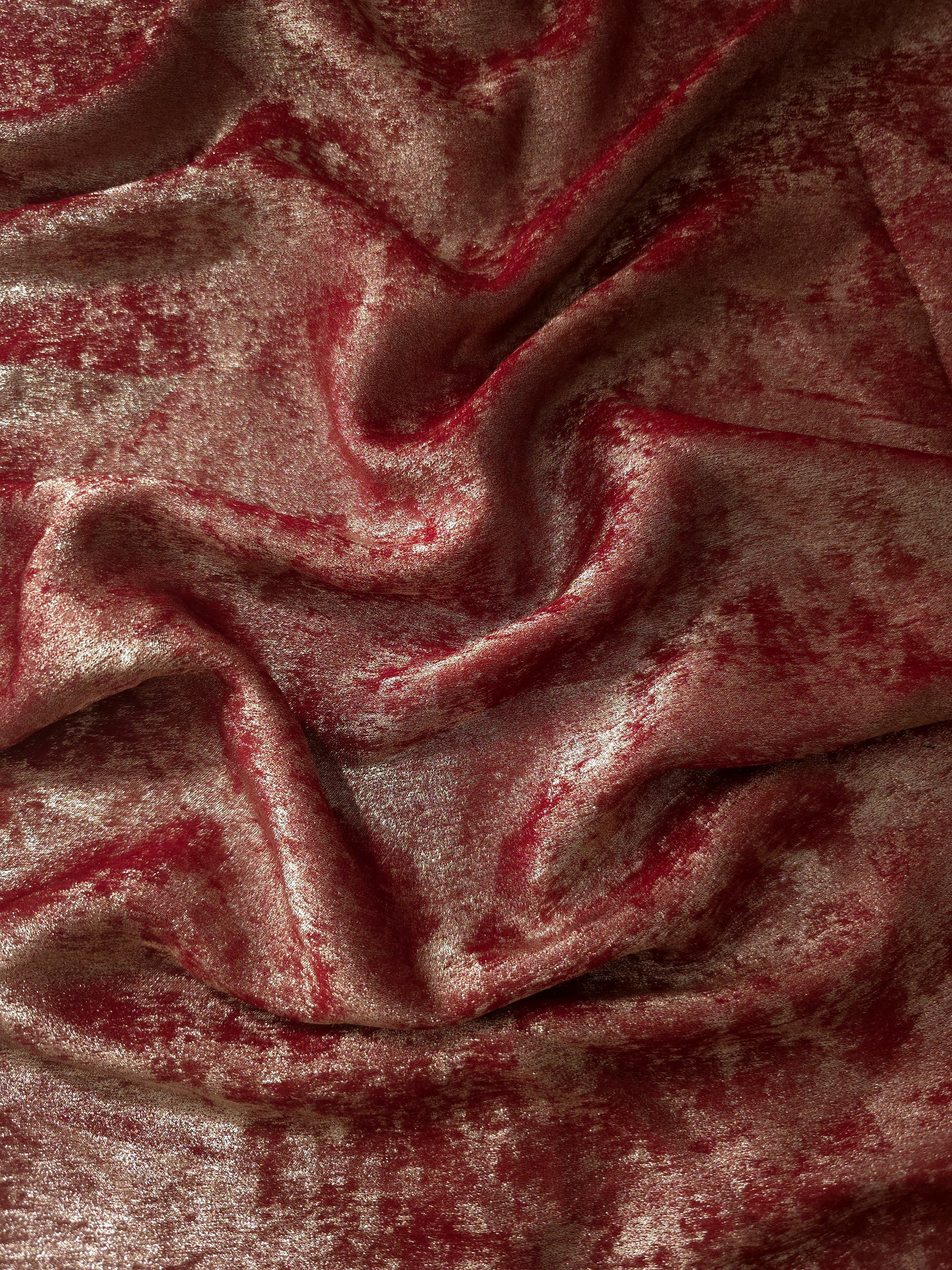 Flowing folds of Garnet Rose Lurex Italiano fabric highlighting drape for abayas, kaftans and dresses.