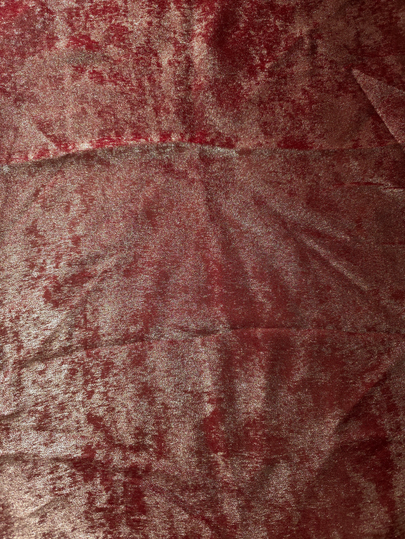 Flat view of Garnet Rose Lurex Italiano fabric showing its metallic foil surface for luxury apparel.