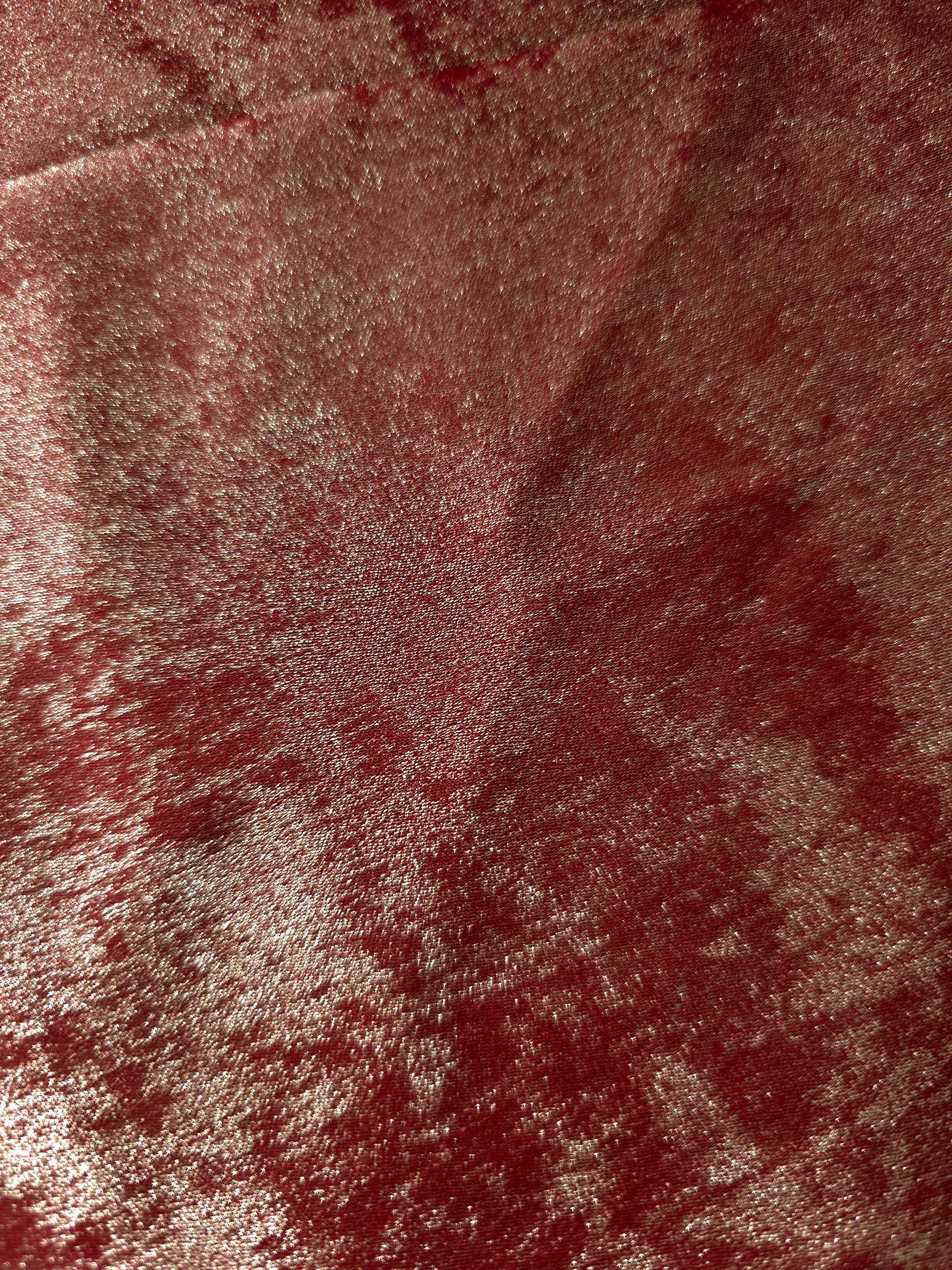 Macro close-up of Garnet Rose Lurex Italiano fabric revealing metallic texture for designer apparel.