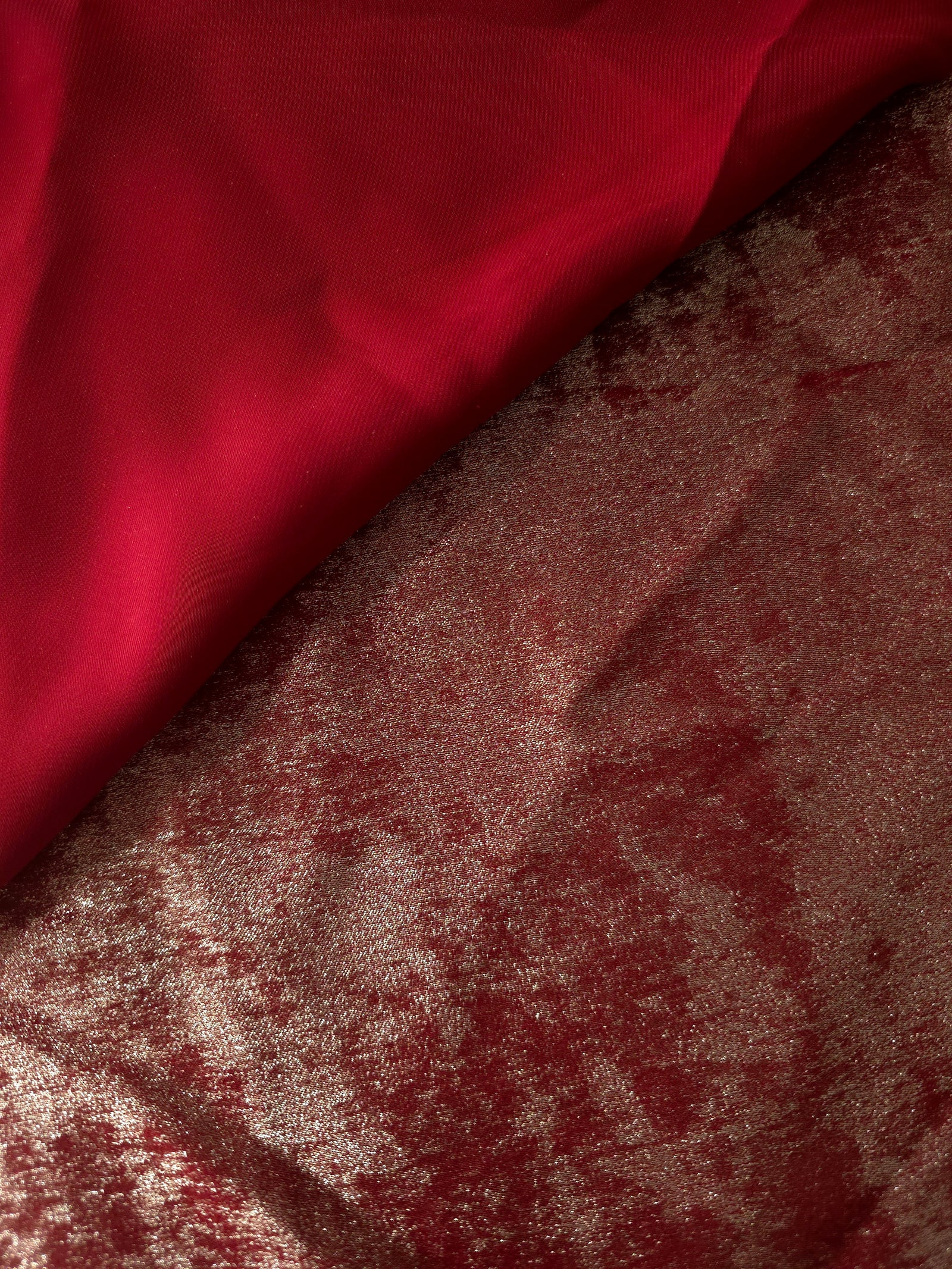 Reverse side of Garnet Rose Lurex Italiano fabric showing the backing and metallic finish for garment production.