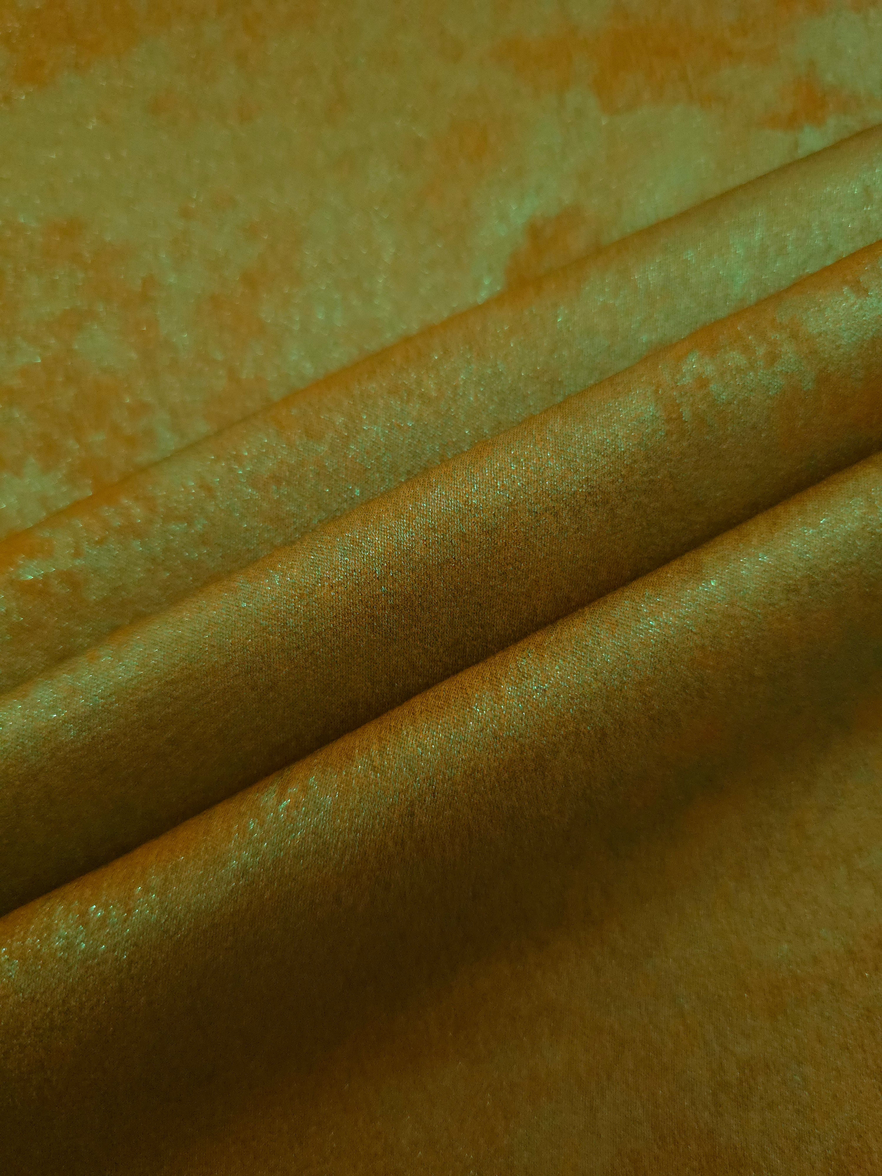 Golden Olive Lurex Italiano fabric in diagonal folds showing metallic sheen and drape for eveningwear.
