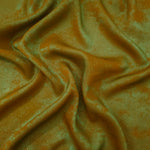 Flowing folds of Golden Olive Lurex Italiano fabric highlighting drape for abayas, kaftans and dresses.