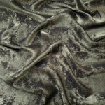 Rosette drape of Graphite Silver Lurex Italiano fabric emphasizing shimmer for kaftans and occasionwear.
