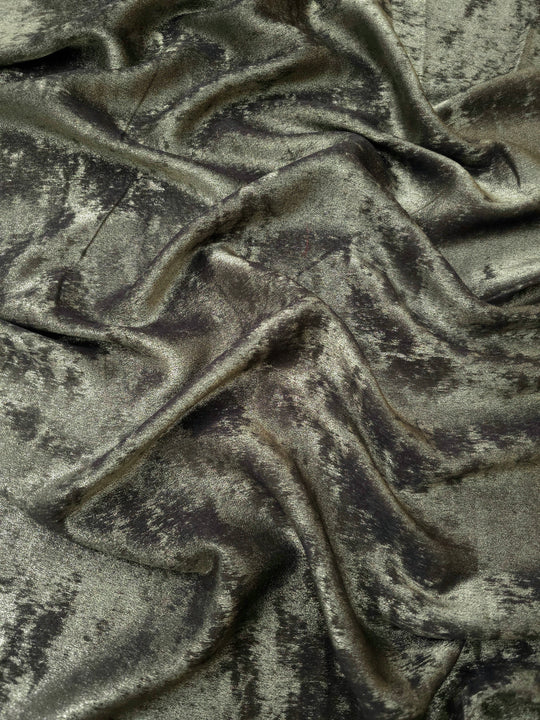 Rosette drape of Graphite Silver Lurex Italiano fabric emphasizing shimmer for kaftans and occasionwear.