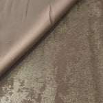 Ivory Pearl Lurex Italiano fabric in diagonal folds showing metallic sheen and drape for eveningwear.