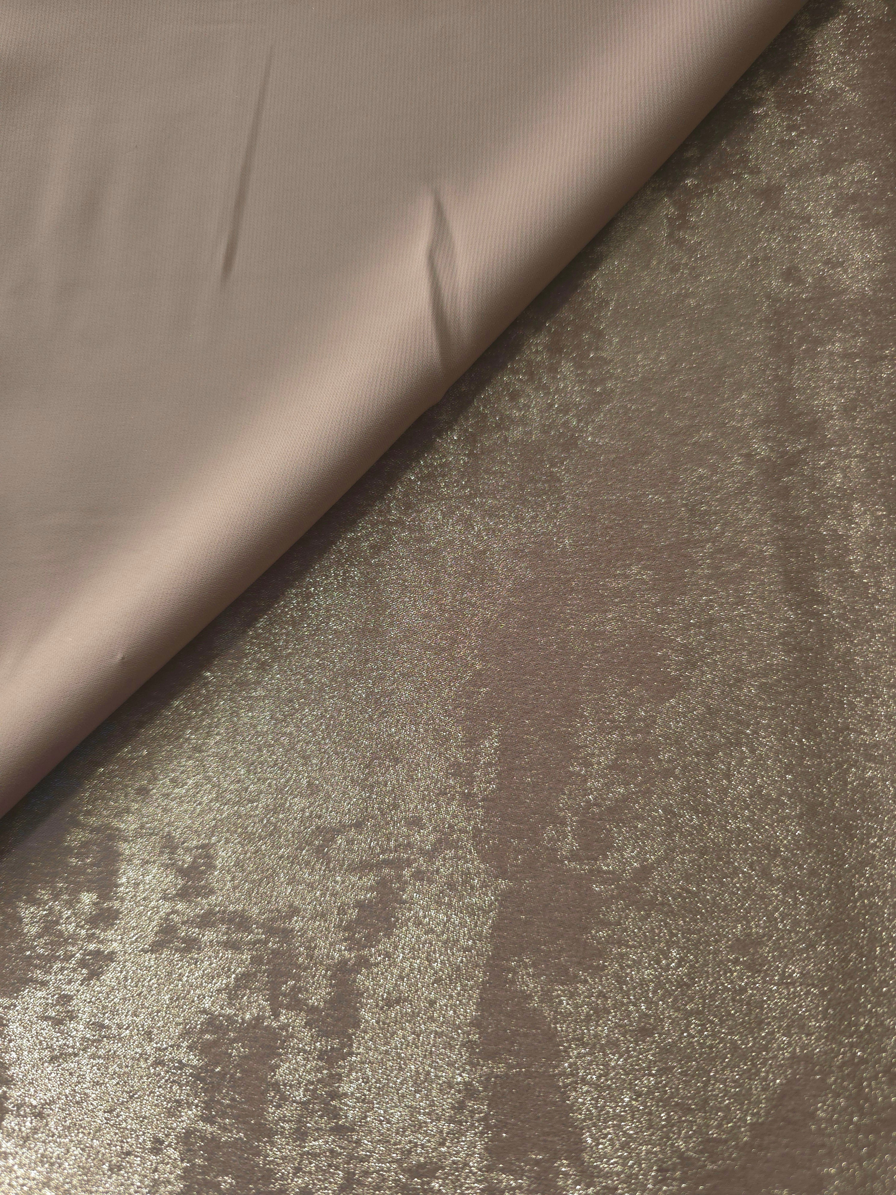 Ivory Pearl Lurex Italiano fabric in diagonal folds showing metallic sheen and drape for eveningwear.