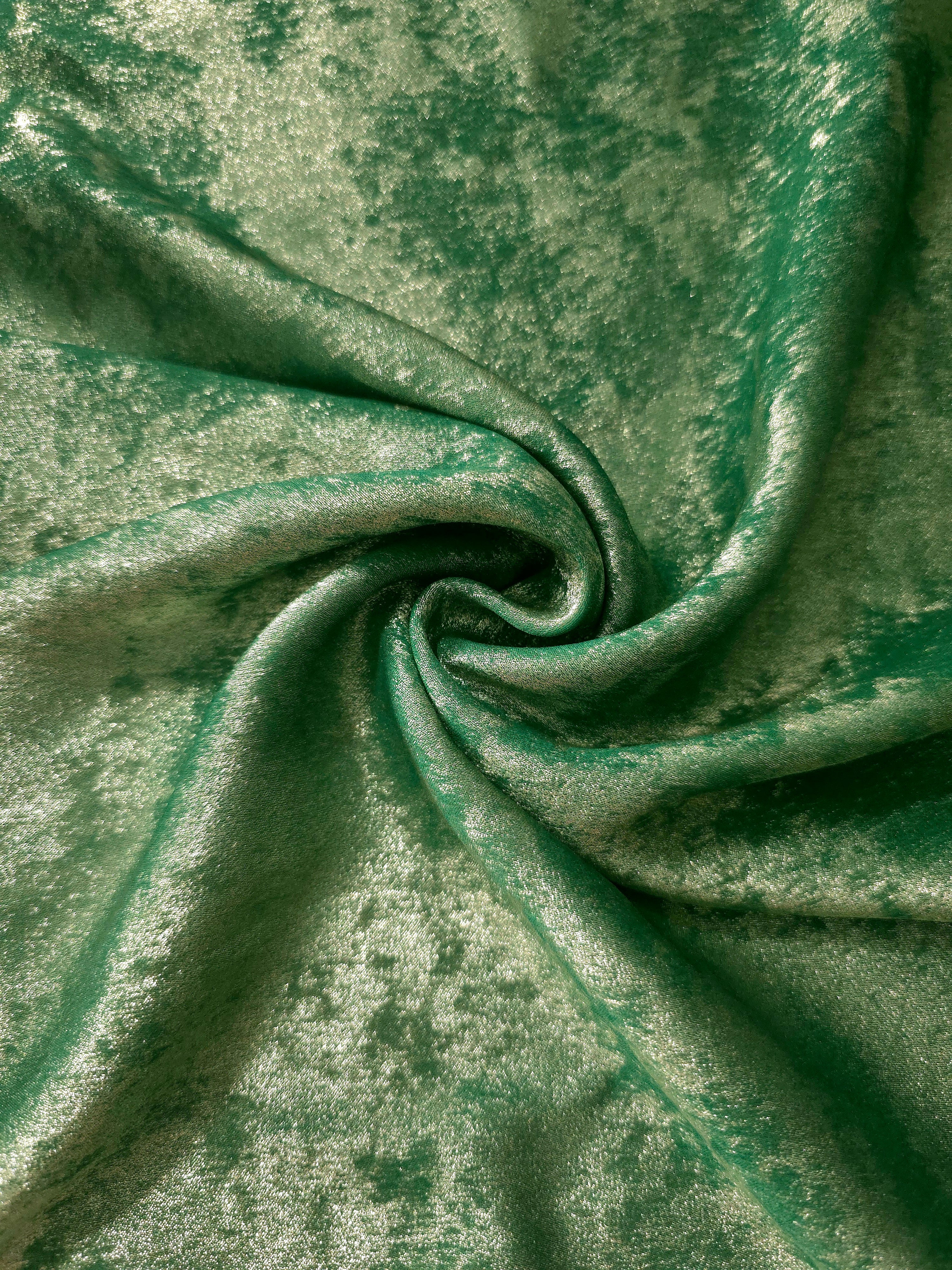 Jade Green Lurex Italiano metallic fabric in a rosette drape with luminous shimmer