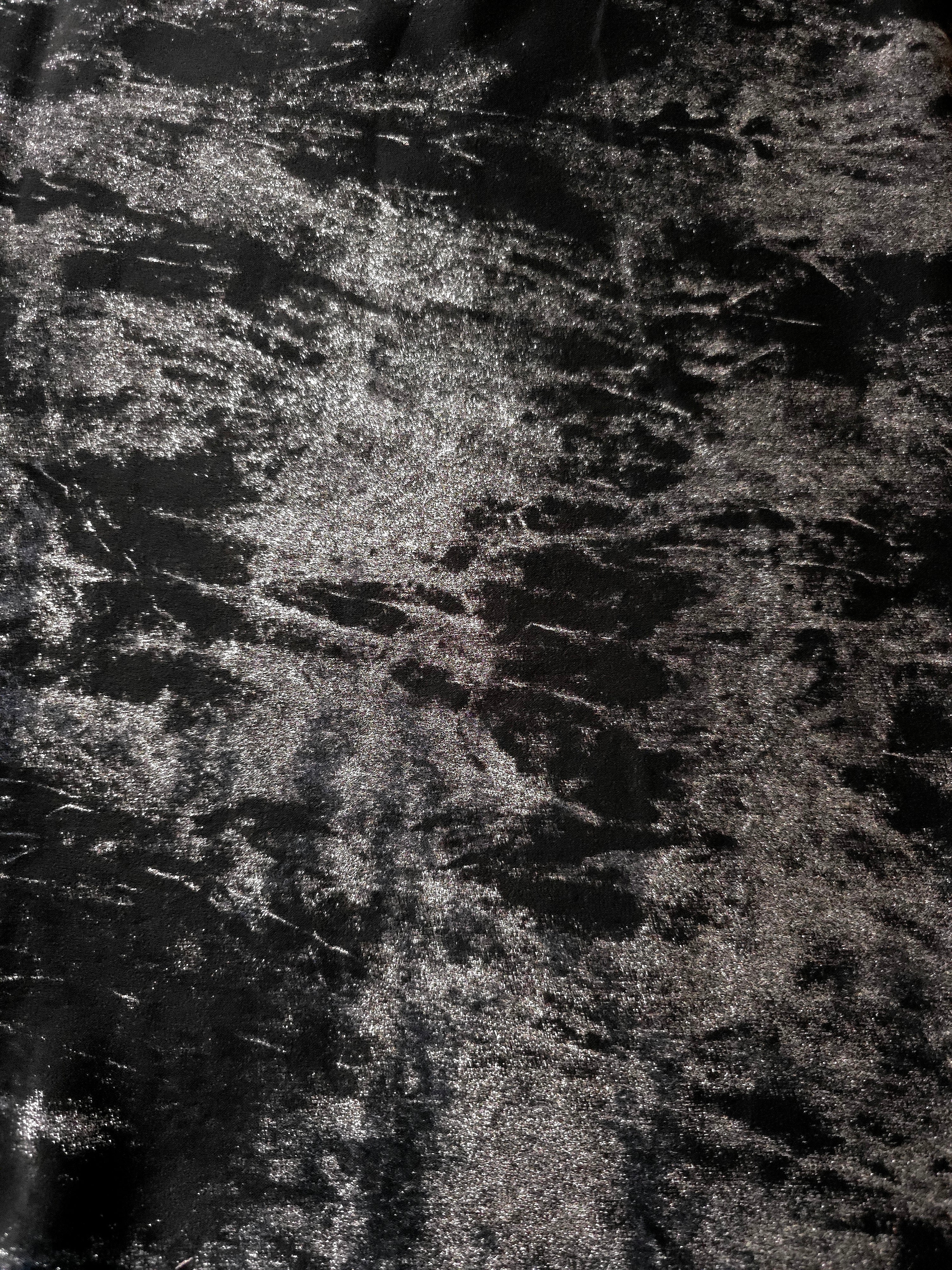 Flat view of Jet Black Lurex Italiano fabric showing its metallic foil surface for luxury apparel.