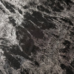 Macro close-up of Jet Black Lurex Italiano fabric revealing metallic texture for designer apparel.