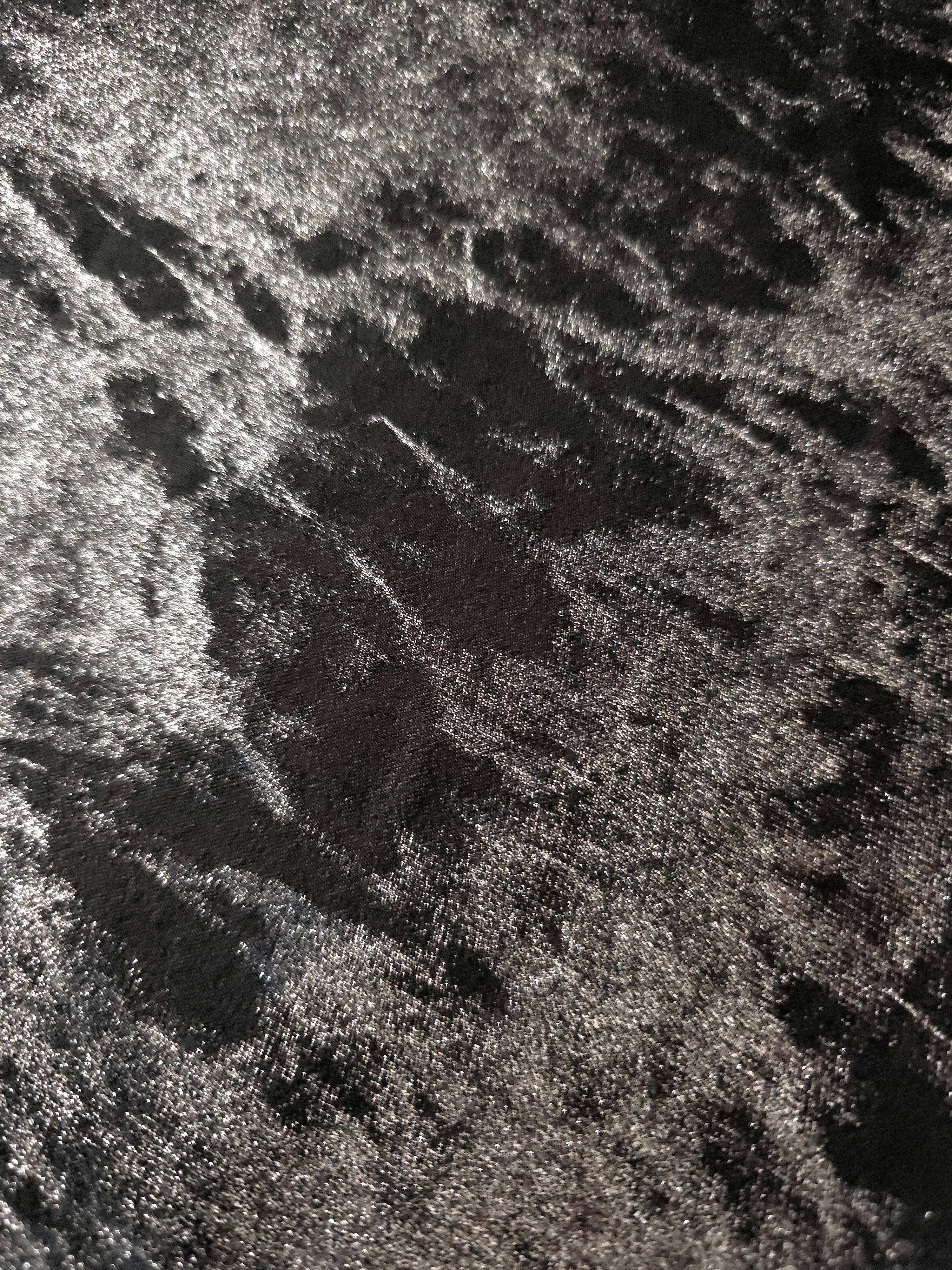 Macro close-up of Jet Black Lurex Italiano fabric revealing metallic texture for designer apparel.